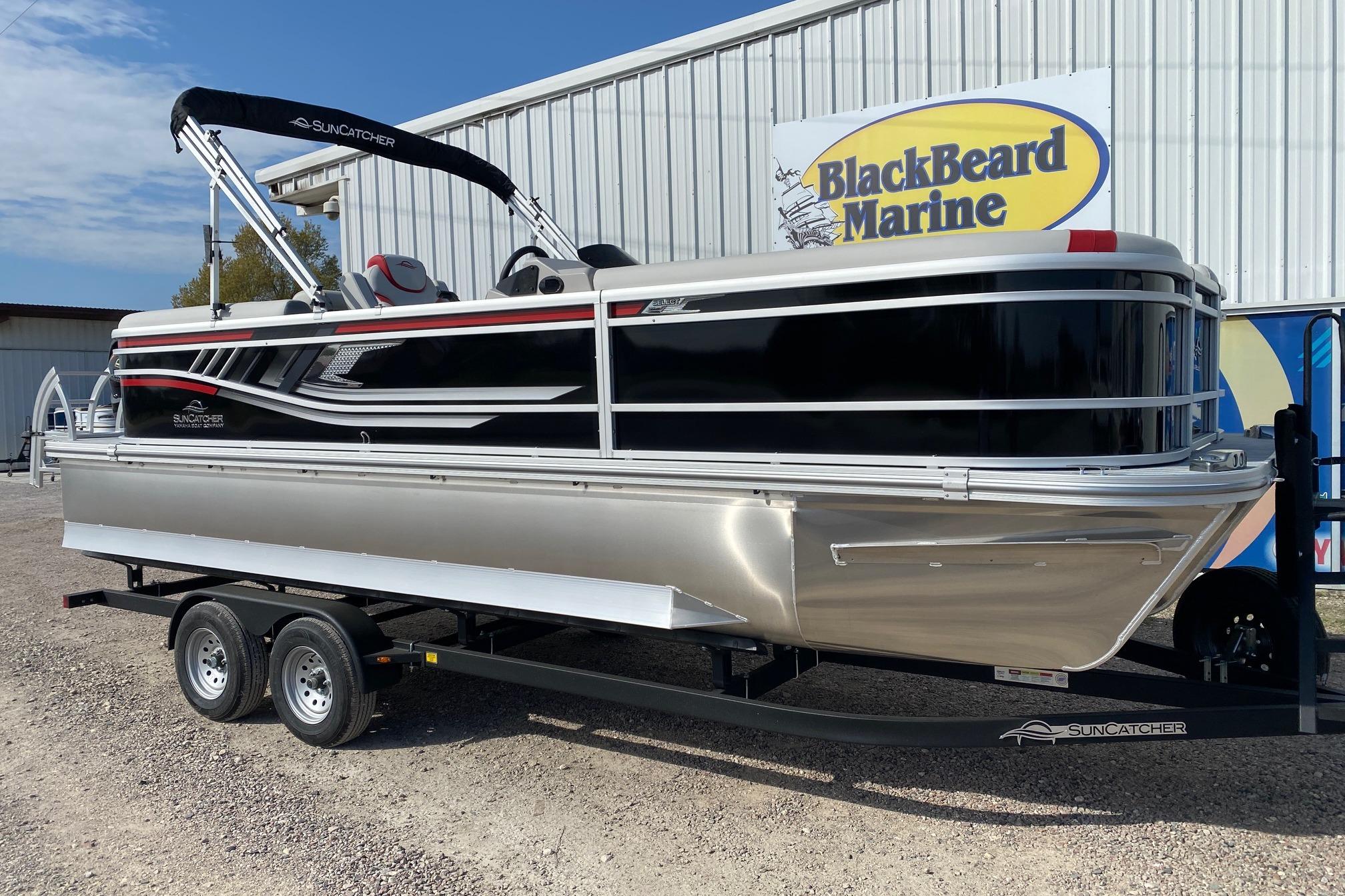2026 SunCatcher Select 322RC pontoon boat on trailer at BlackBeard Marine dealership.