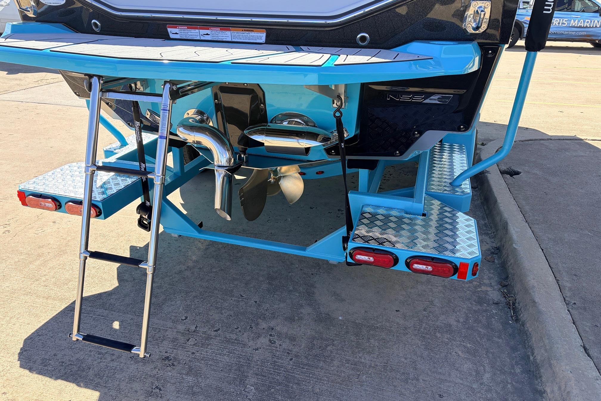 2026 Nautique Super Air Nautique G23 boat rear view with ladder and platform.