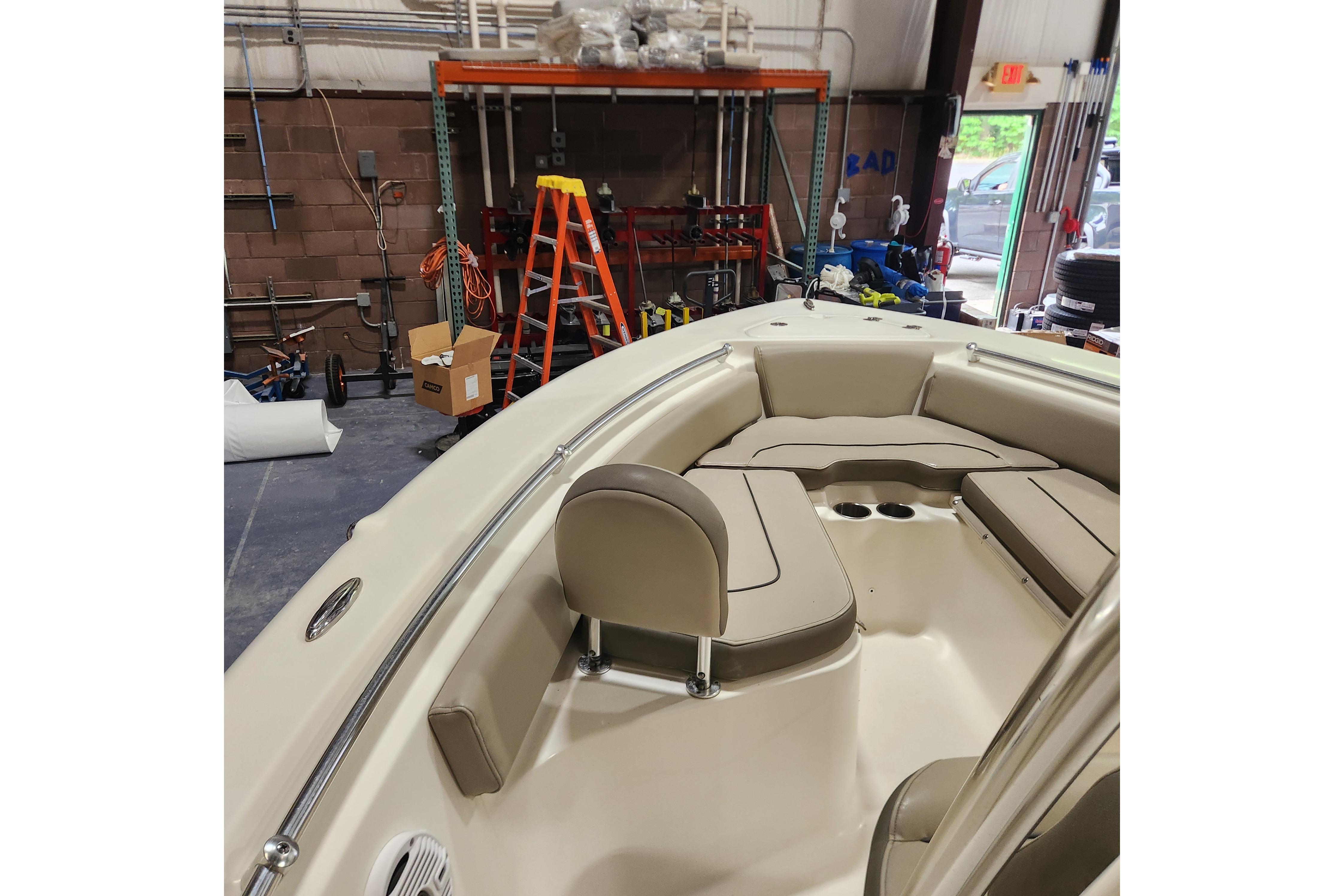 2023 Key West 219 FS boat interior with beige seating in a workshop setting.