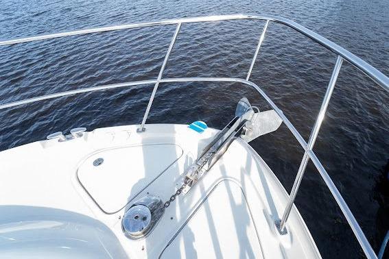 2006 Sea Ray 580 Sedan Bridge bow with anchor, overlooking calm water.