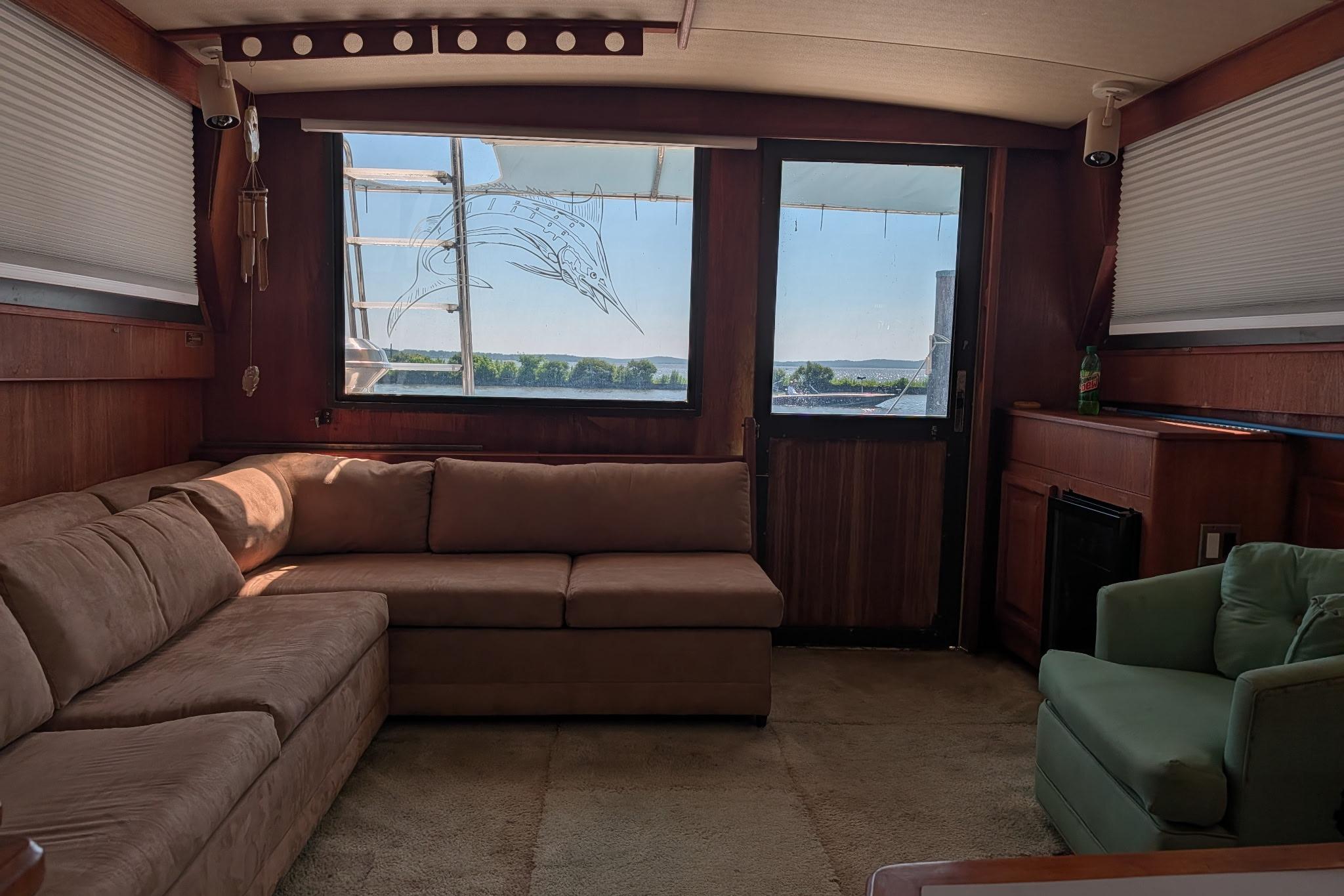 Interior of 1986 Viking Sportfish 41 yacht with cozy seating and scenic window view.