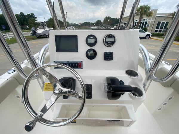 2024 Key West 203 FS boat dashboard with steering wheel and control panel.