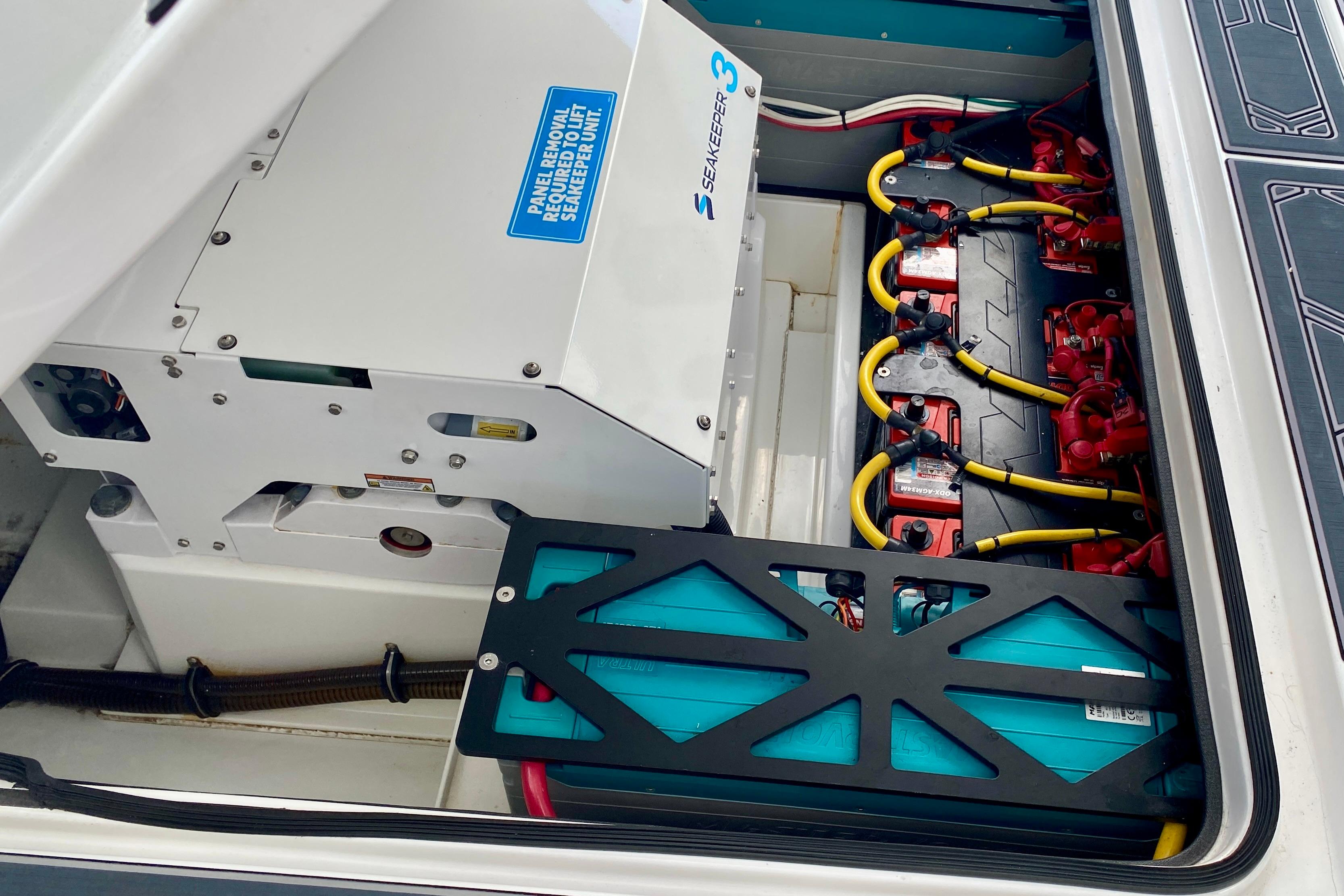 Engine compartment of 2024 MTI V50 with Seakeeper 3 and battery setup.