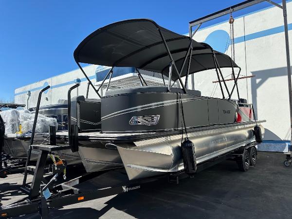 2025 Tahoe Pontoon 2585 LTZ Entertainer boat on trailer, black canopy, outdoor display.