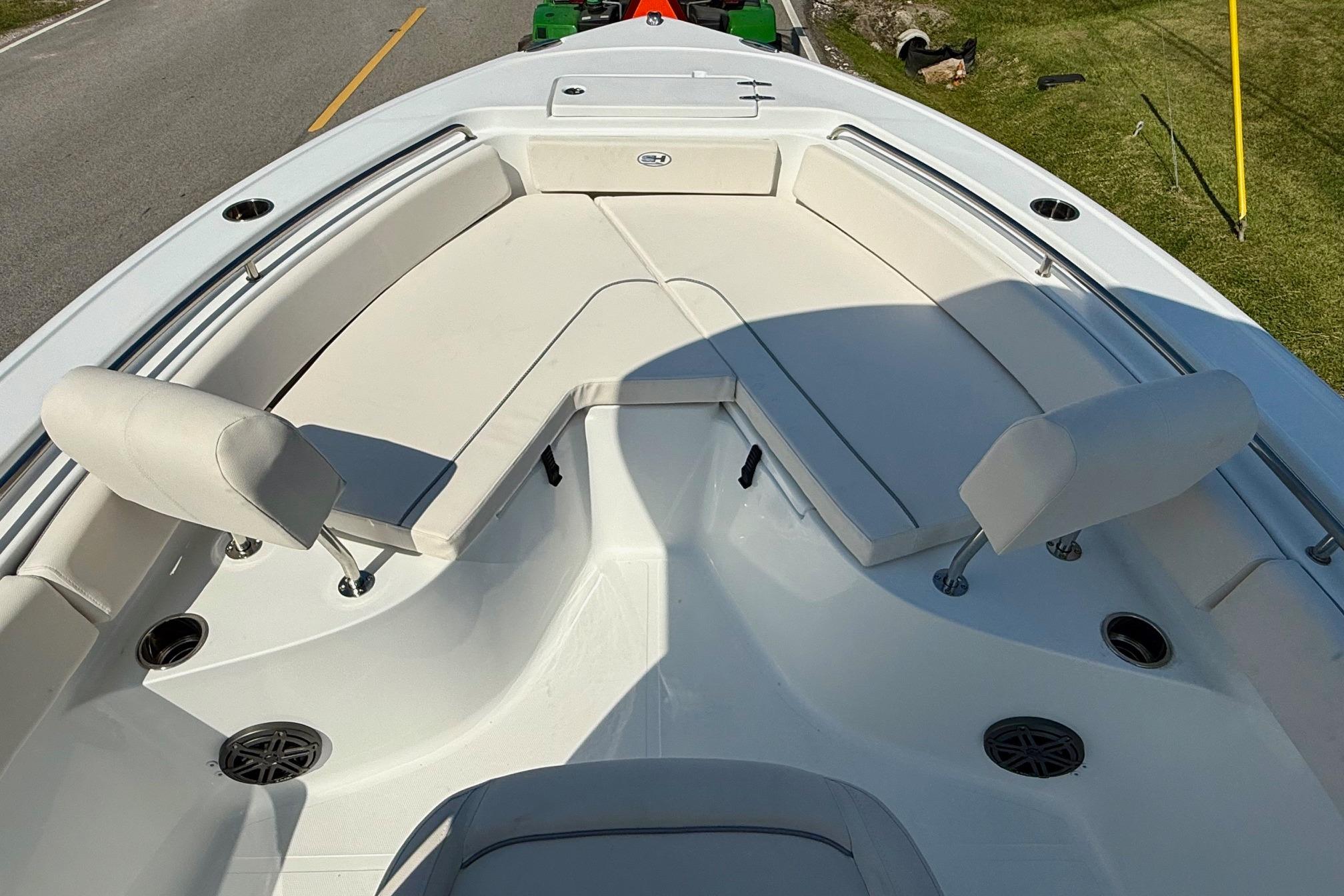 2026 Sea Hunt Ultra 229 boat interior with cushioned seating and cup holders.