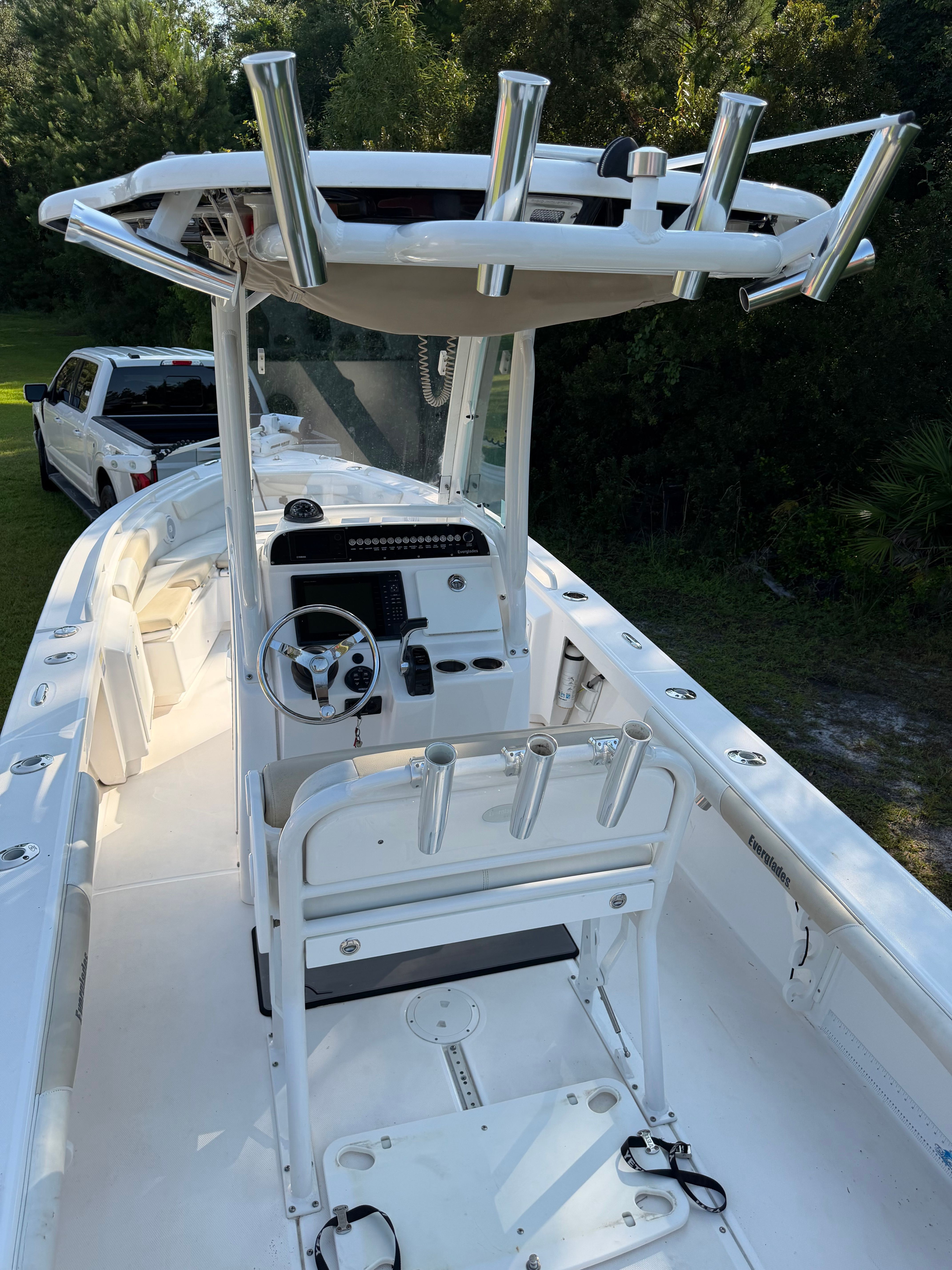 A 2016 Everglades 243 Center Console boat with a white deck and helm station.