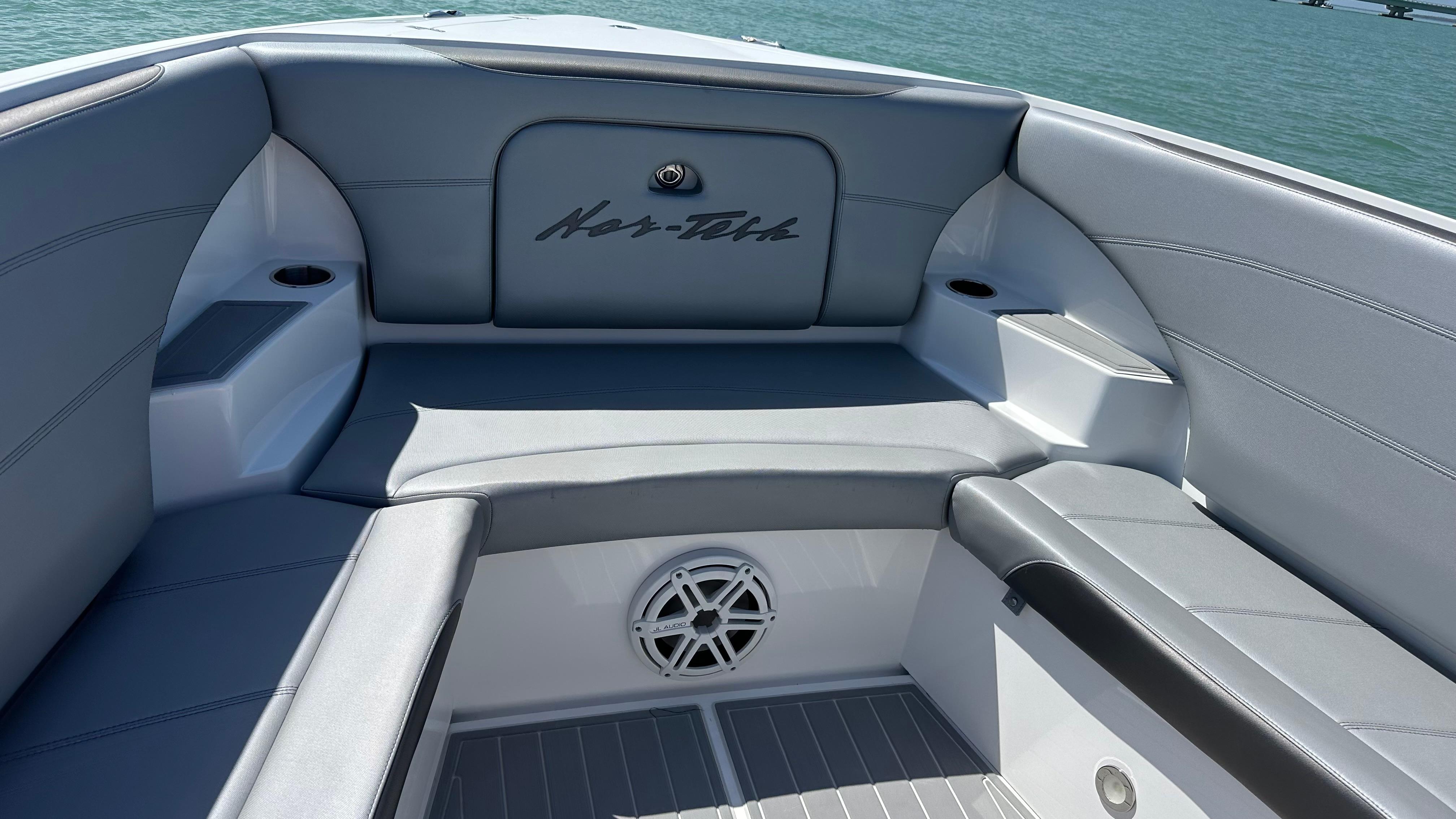 2018 Nor-Tech 340 Sport Center Console boat interior with gray seating and speaker.