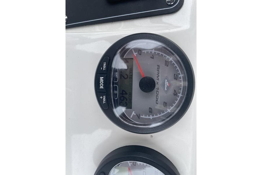 Close-up of 2012 Boston Whaler 250 Outrage tachometer displaying RPM and mode settings.