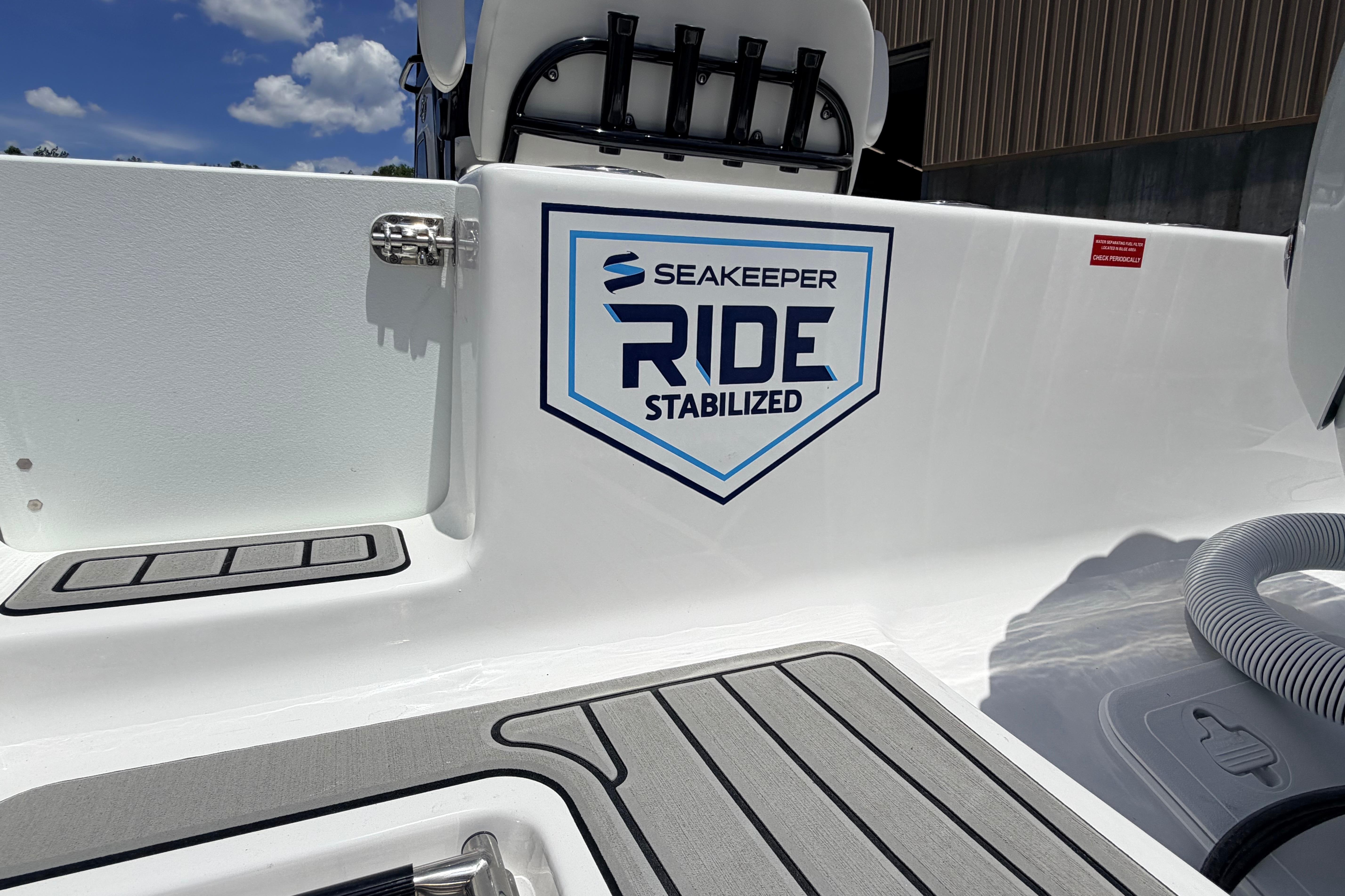 2027 Tidewater 232 CC Adventure boat with Seakeeper Ride Stabilized feature, sunny day.