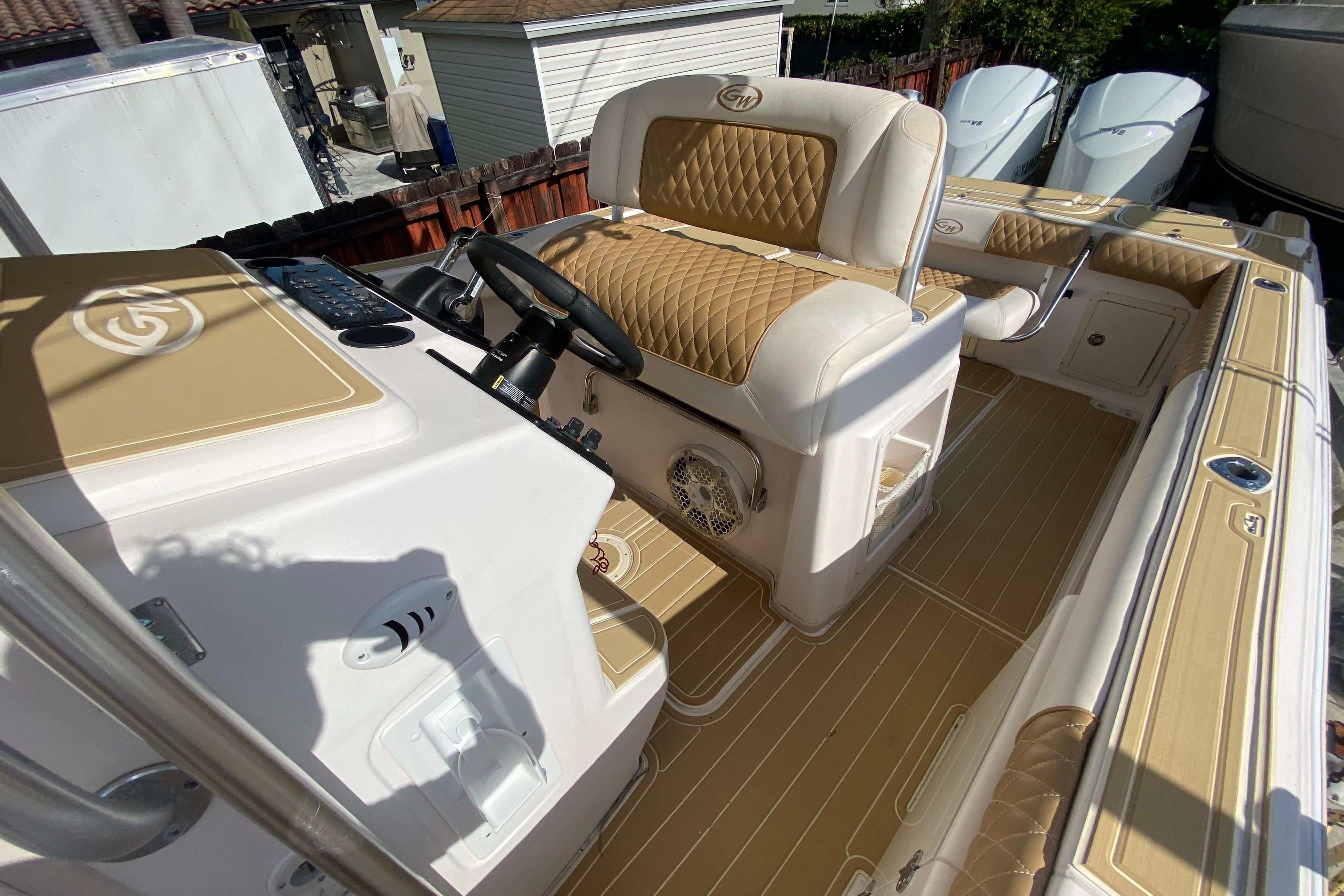 2004 Grady-White Canyon 283 boat interior with tan and white seating and helm.