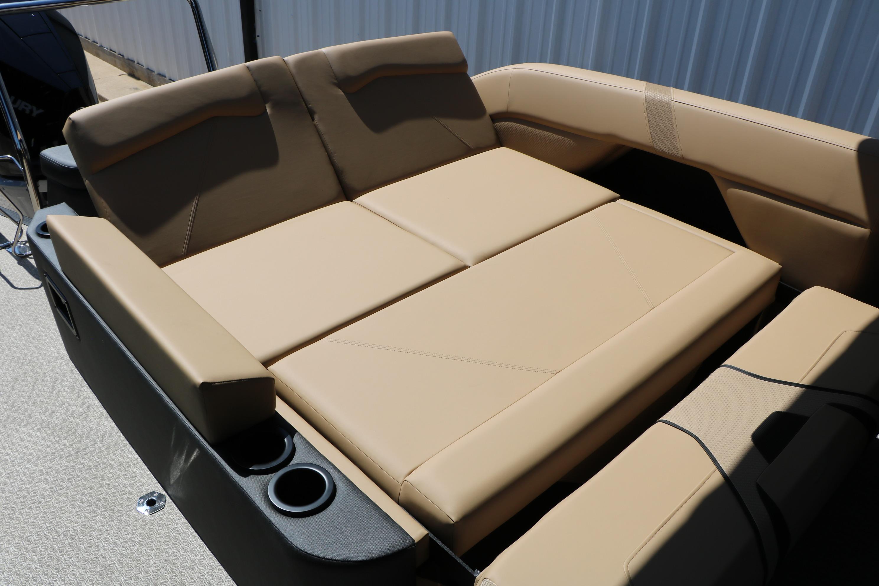 Luxurious seating area on 2026 Evotti 725 CS Tri-Toon boat with beige upholstery.