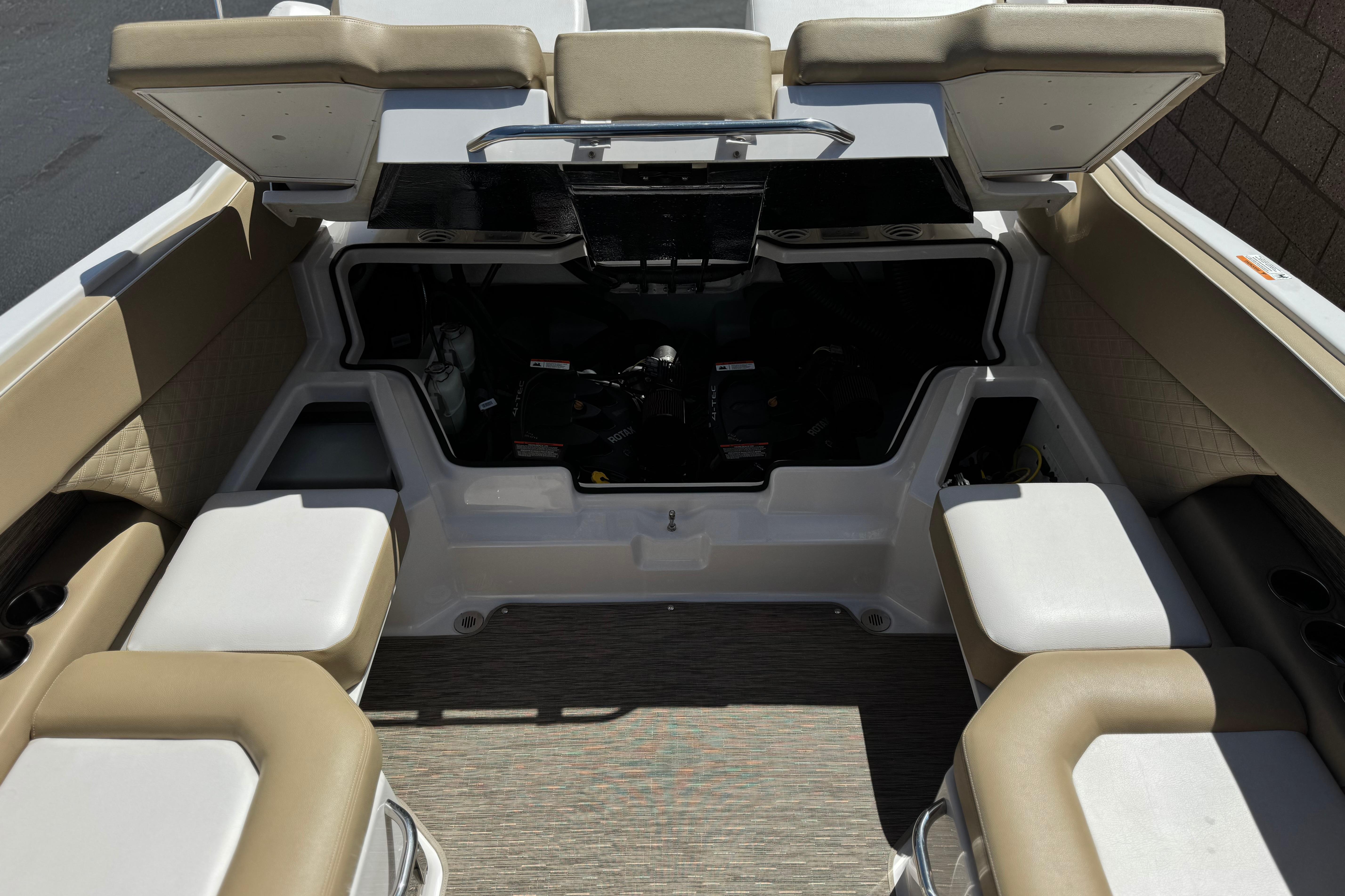 2017 Scarab 255 H.O. Platinum boat interior with beige seating and open storage compartment.