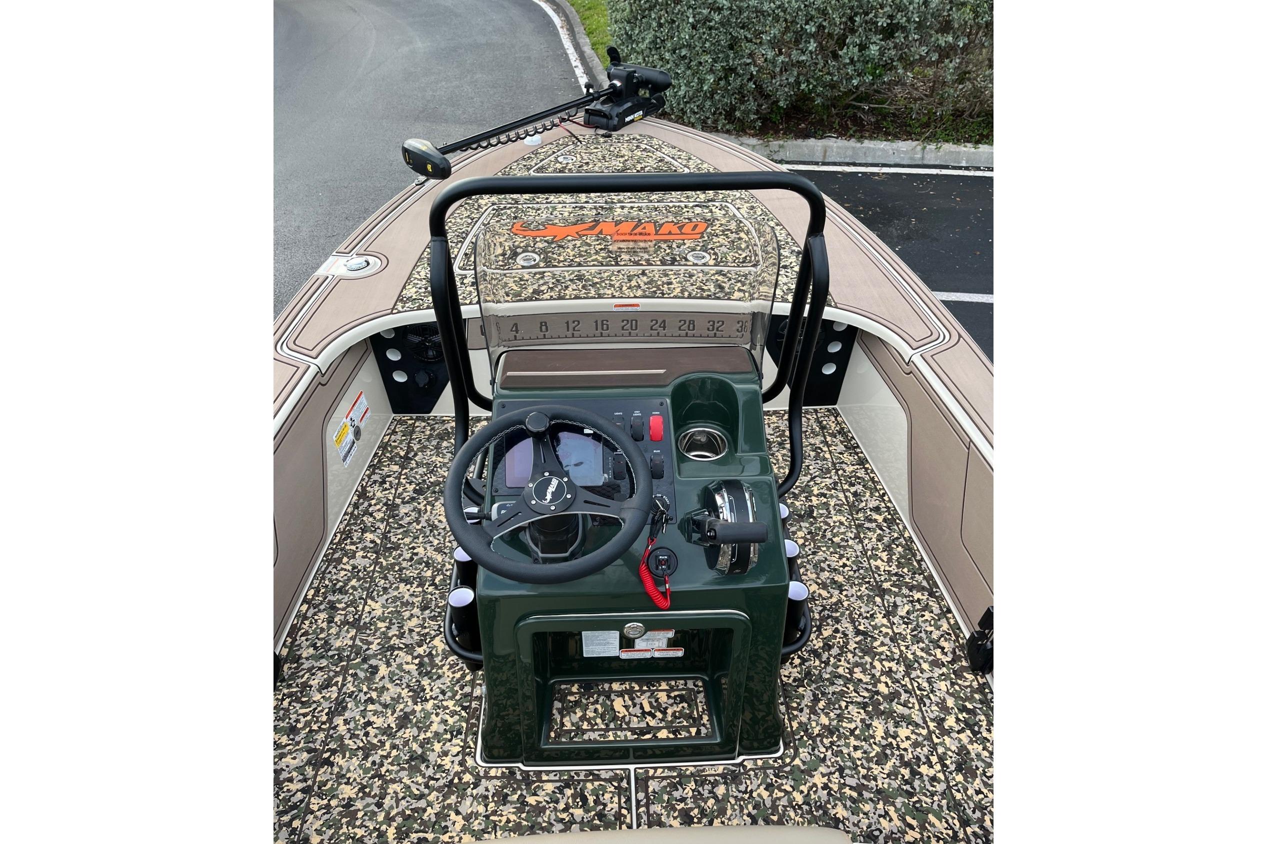2026 Mako 18 Pro Skiff Backwater Edition boat interior with camo design and steering console.