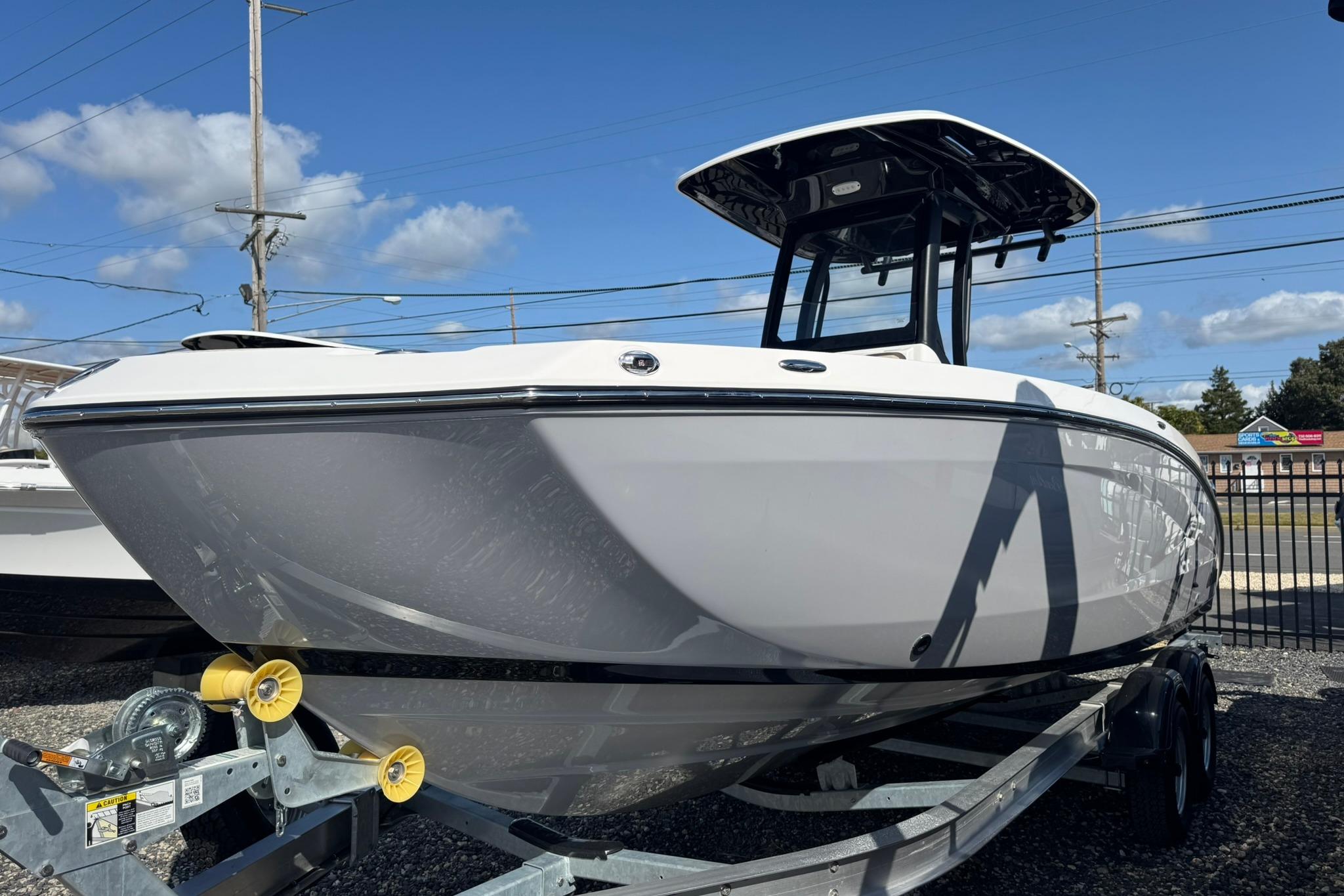 2026 Yamaha Boats 255 FSH Sport H on trailer under clear blue sky.
