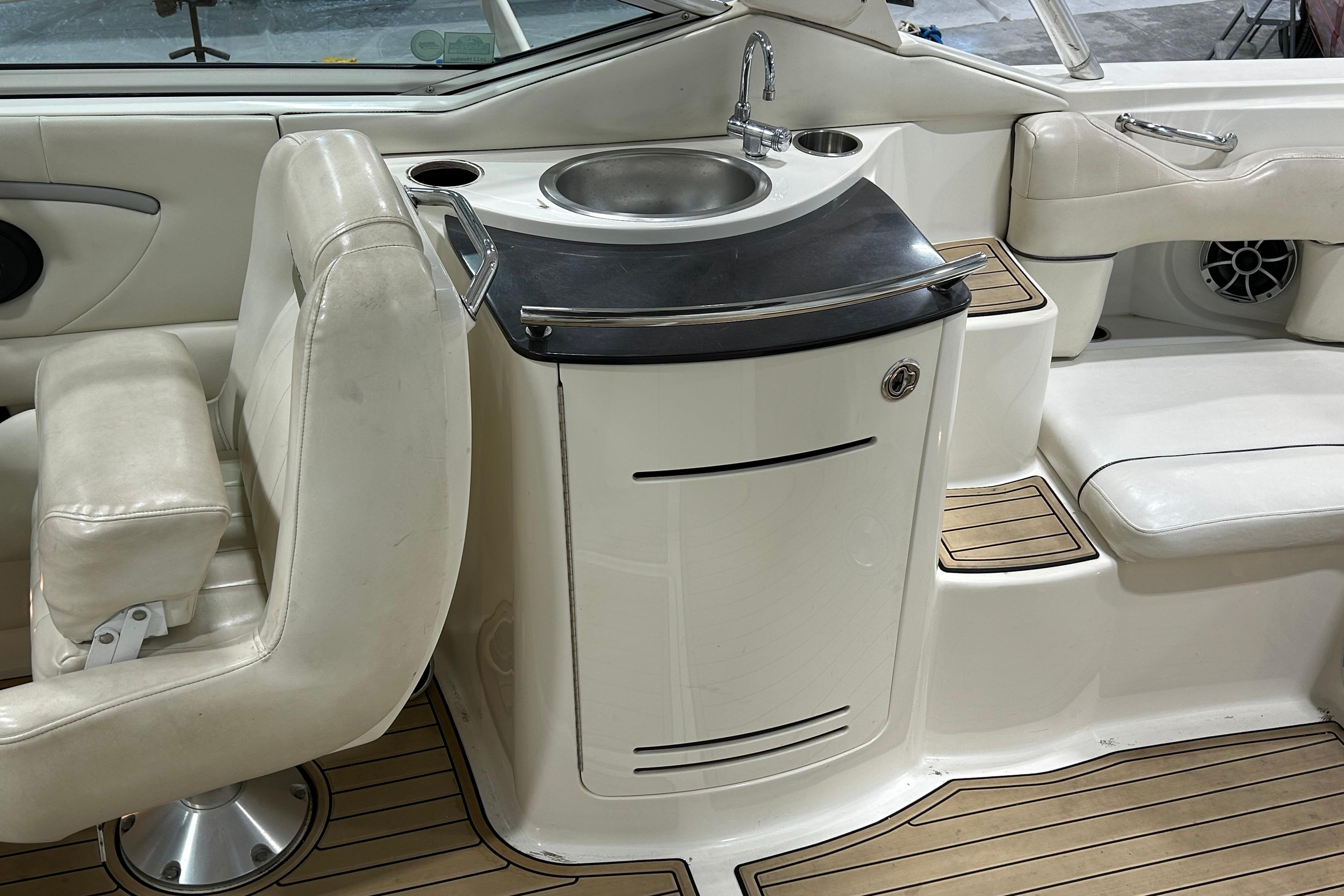 Interior of 2006 Sea Ray 270 SLX boat with sink and seating area.