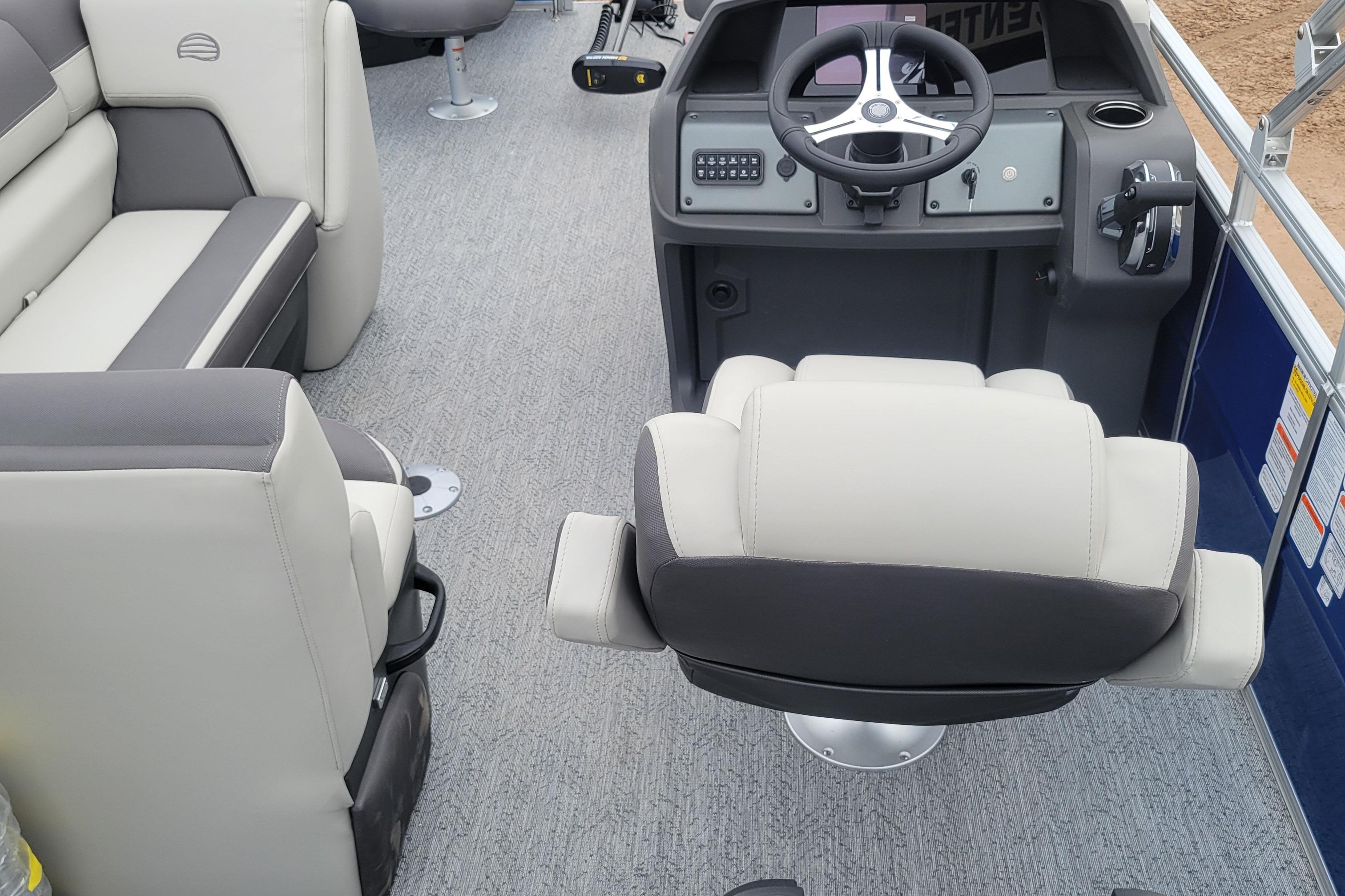 2026 Sun Tracker Fishin' Barge 20 DLX interior with steering console and seating.