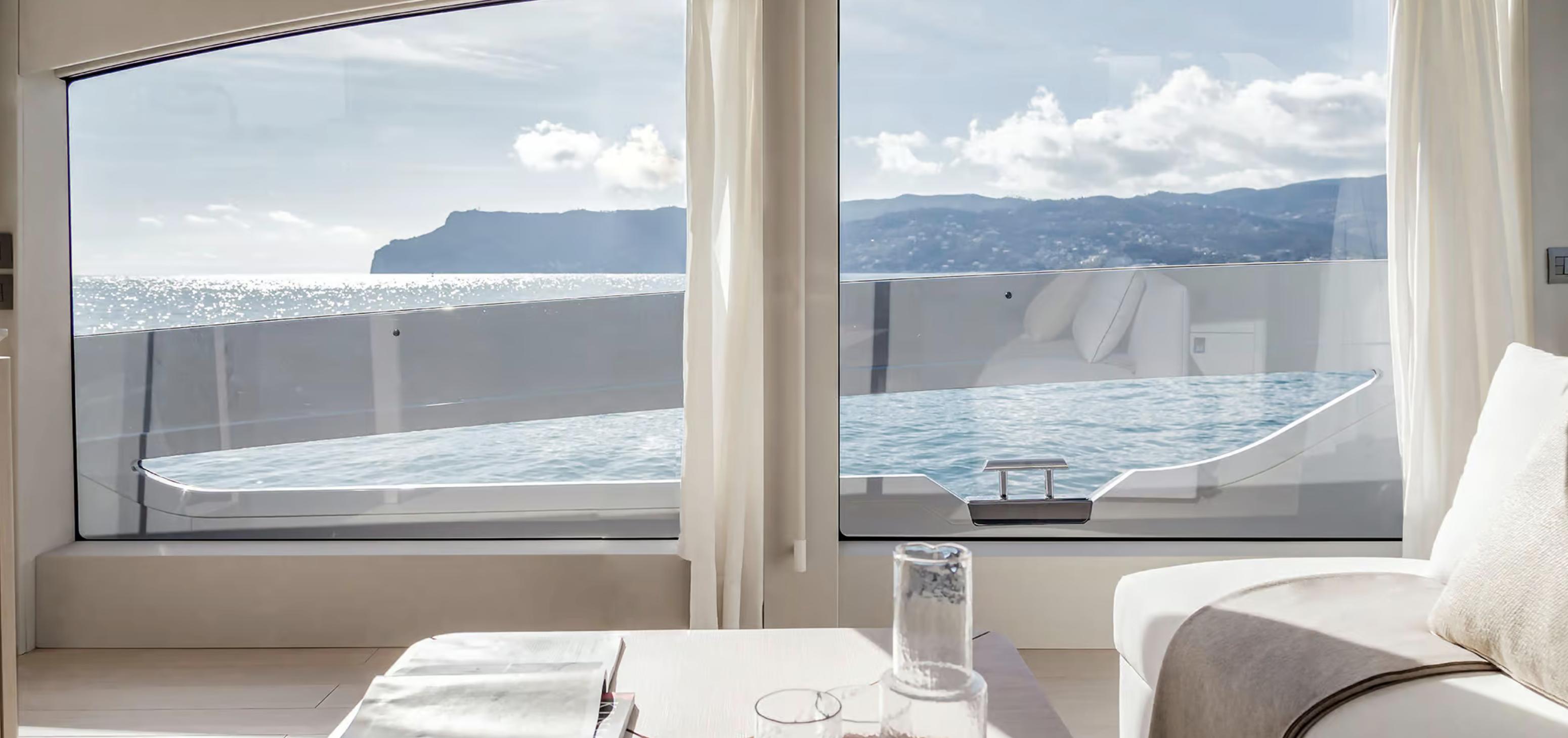 Luxurious interior view from 2025 Azimut Seadeck 6 yacht, overlooking ocean and coastline.