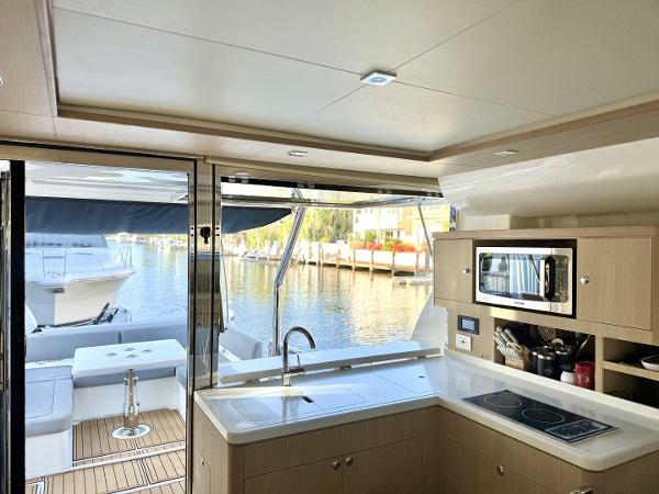 Modern kitchen interior of 2022 Aquila 44 yacht with waterfront view.