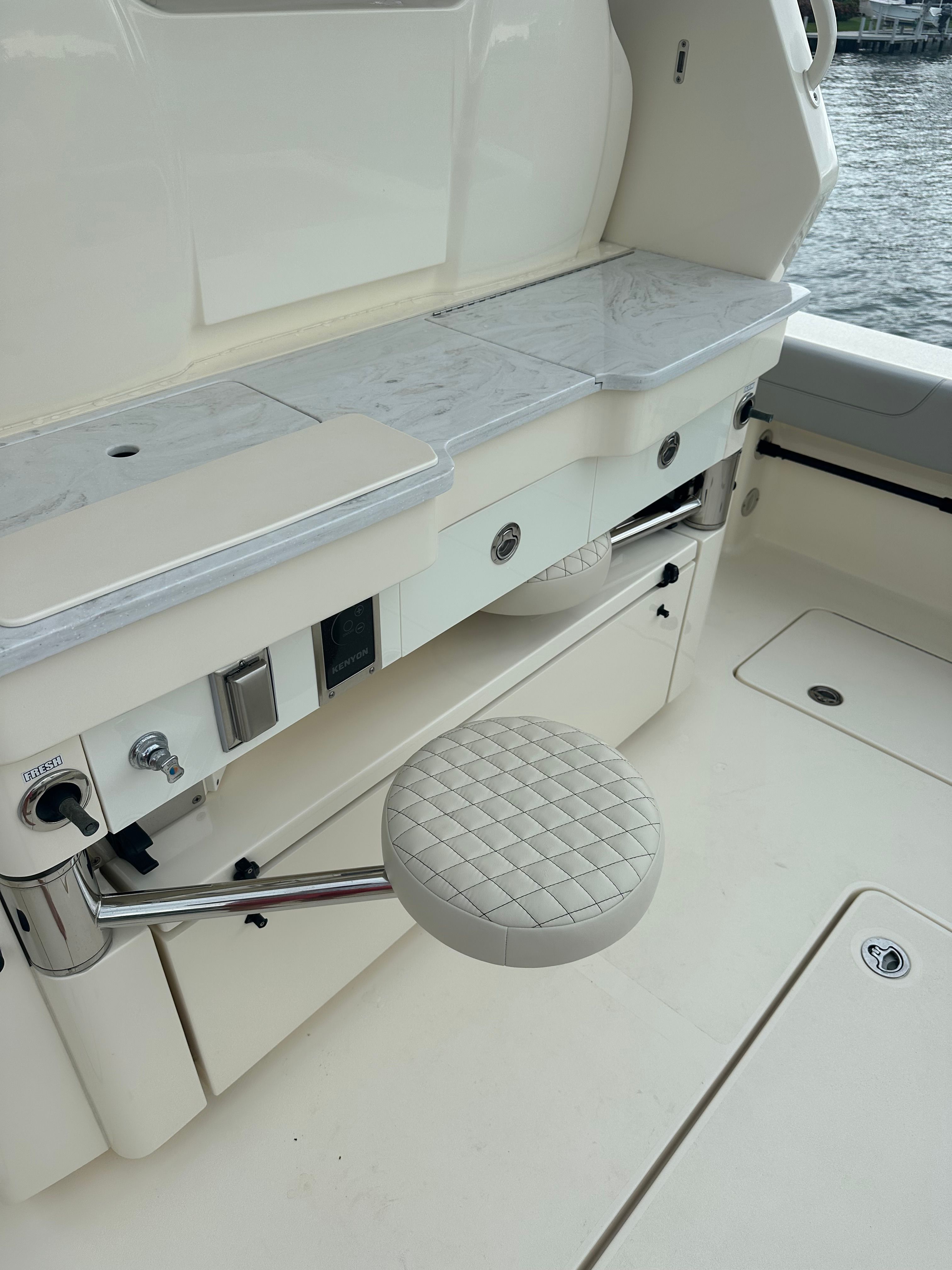 Interior of a 2022 Scout 425 LXF boat with seat and countertop.