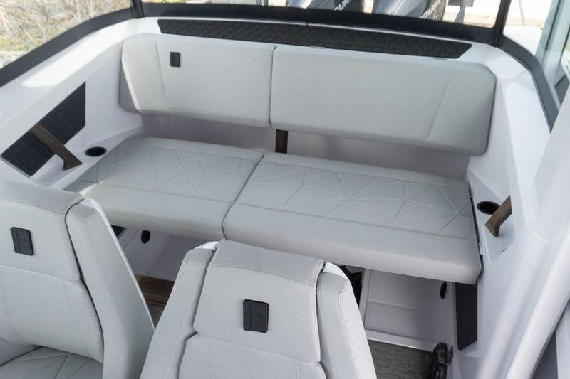 2025 Axopar 29 XC Cross Cabin interior with white cushioned seating and modern design.