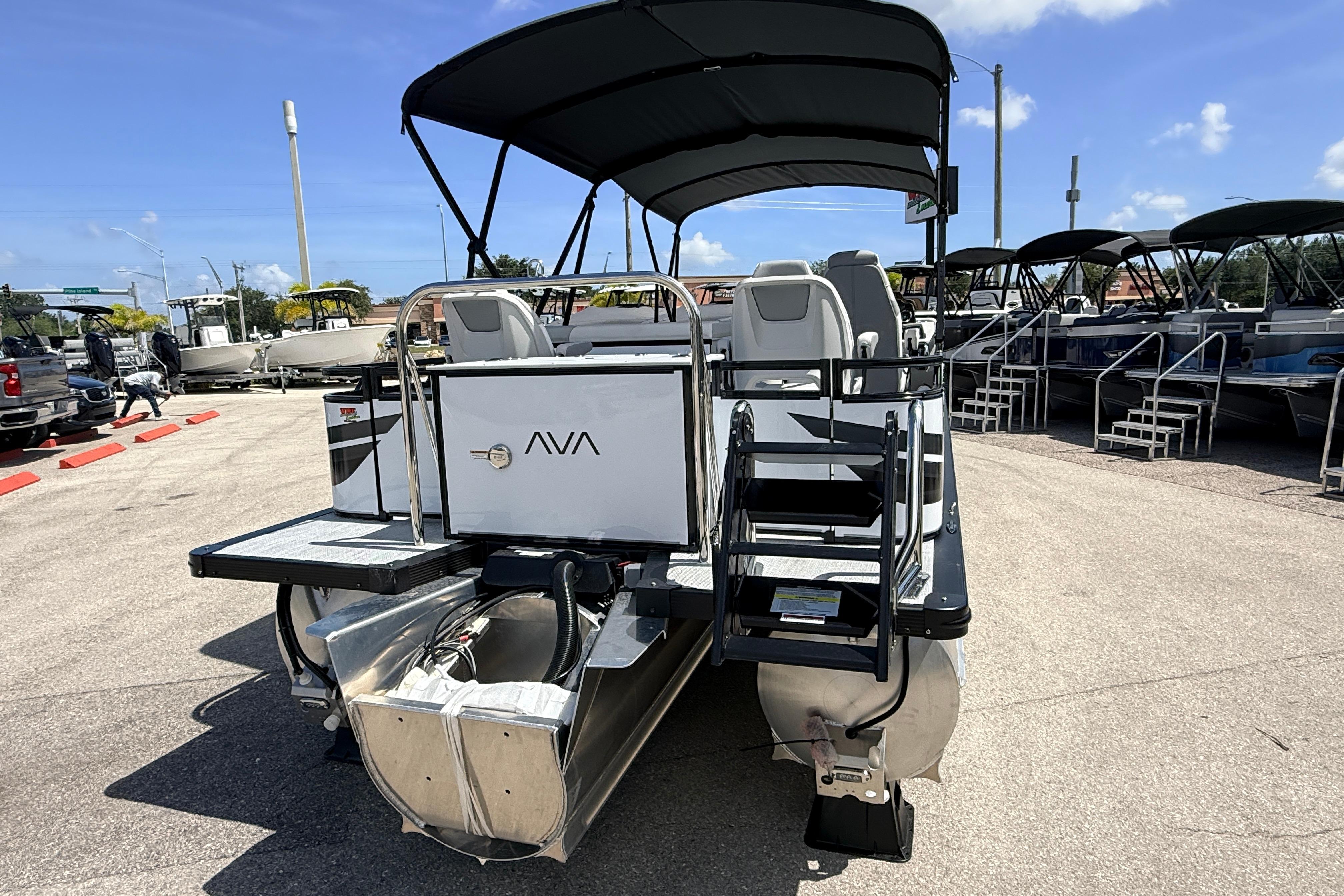 2026 Avalon 2385 Venture 85 Rear Fish Tri Toon boat in a dealership lot.