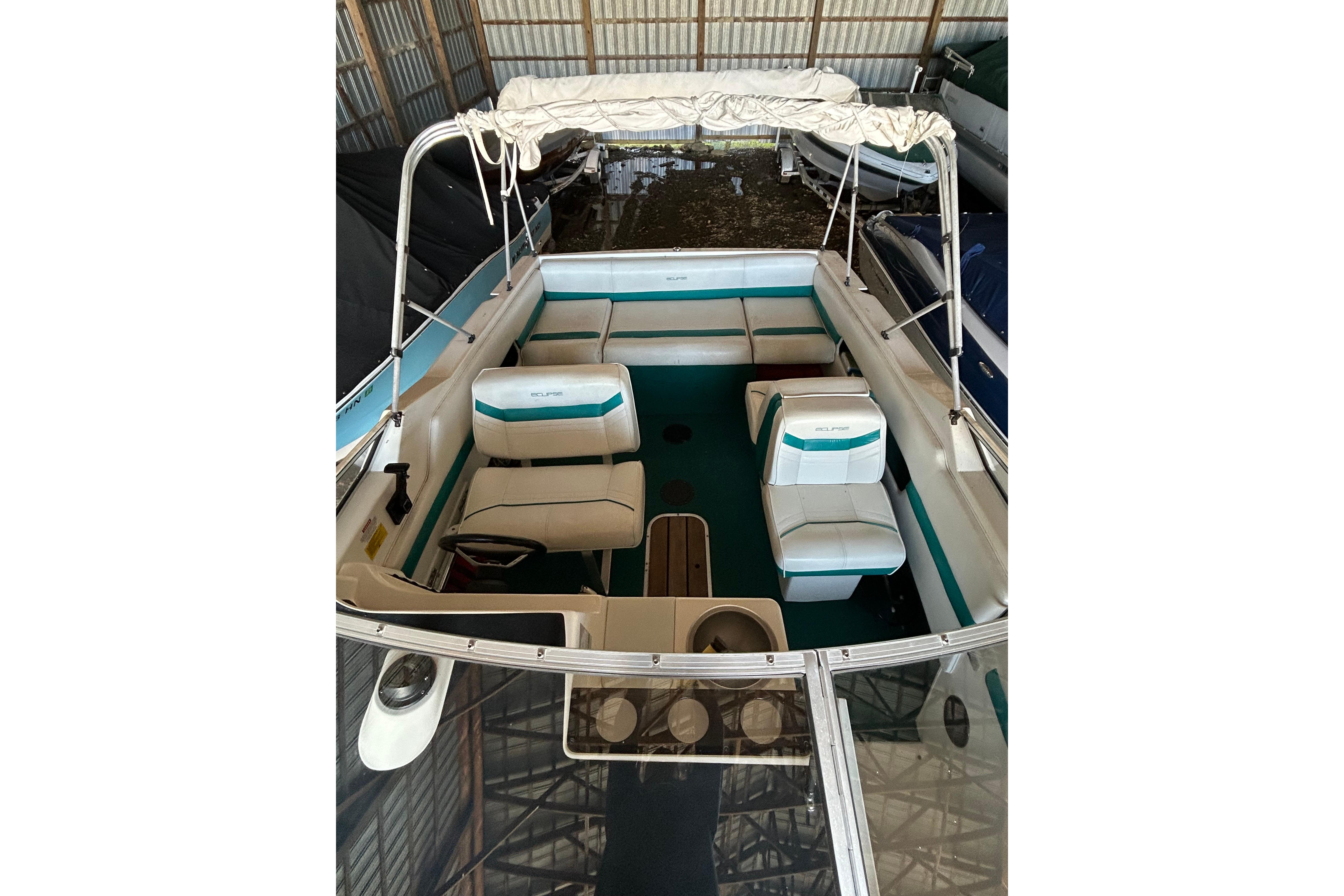 1991 Wellcraft 232 Eclipse boat interior with seating and canopy in storage.