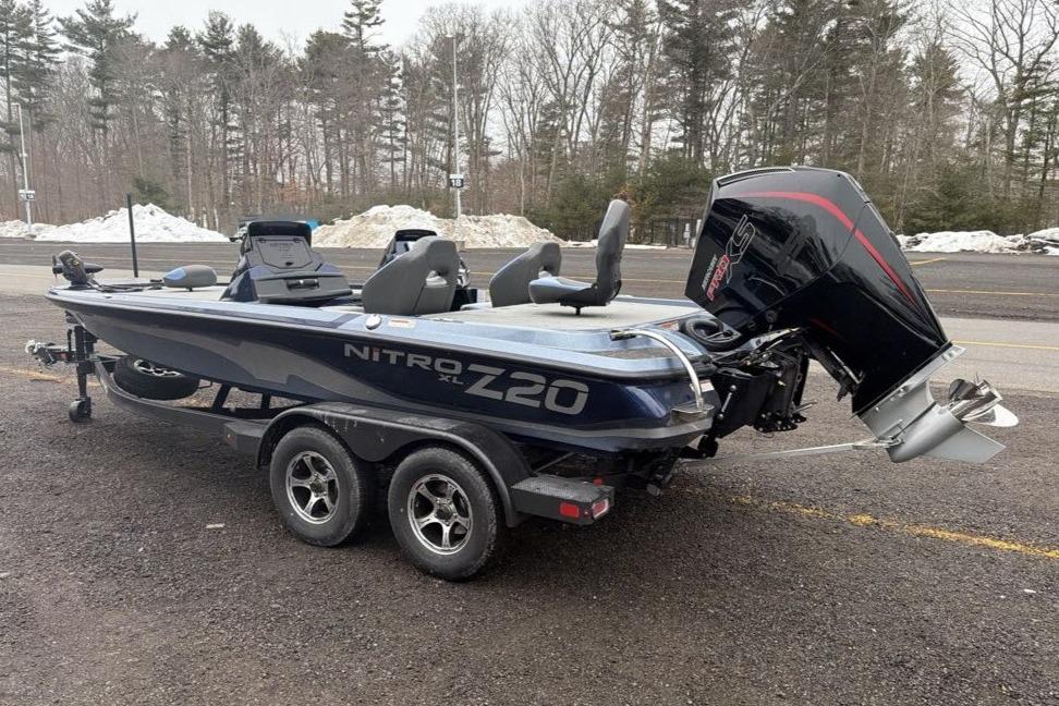 2026 Nitro Z20 XL boat on trailer, parked in snowy wooded area.