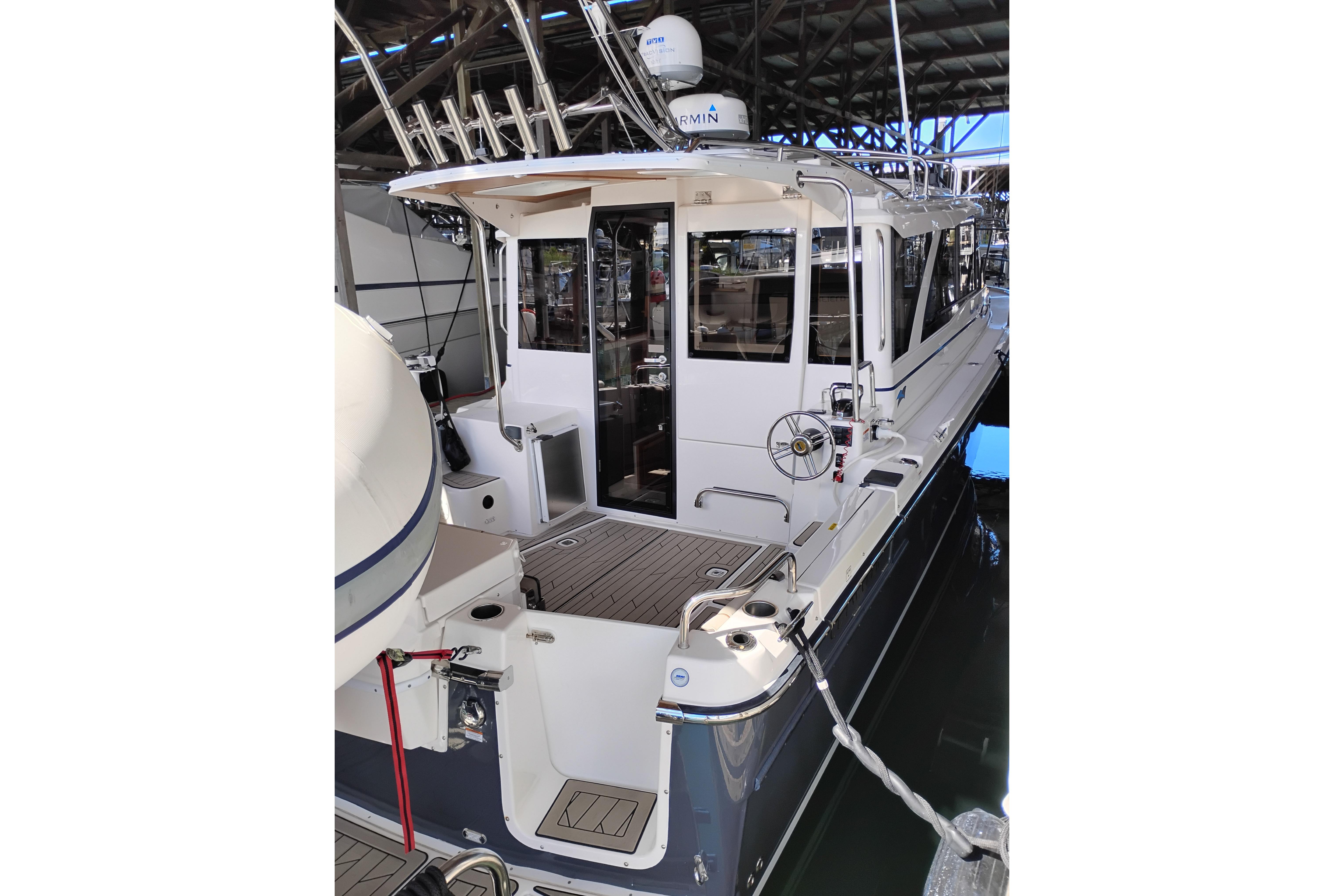 2022 Cutwater C-32 Coupe docked in a marina, showcasing its sleek design and modern features.