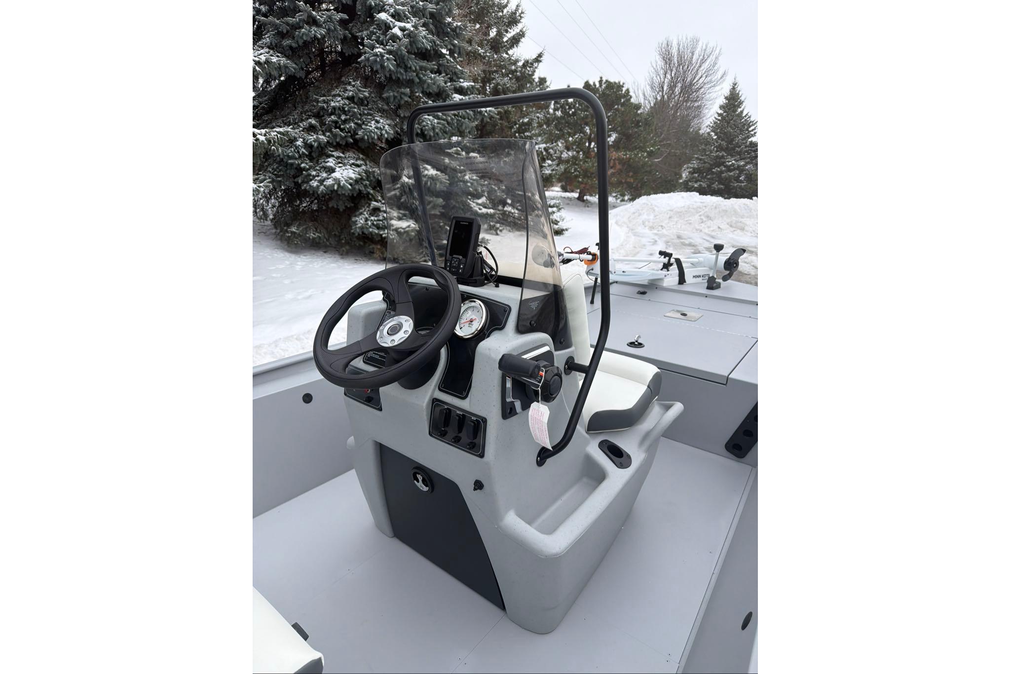 2026 Tracker Bass Tracker Classic CC boat console in snowy outdoor setting.