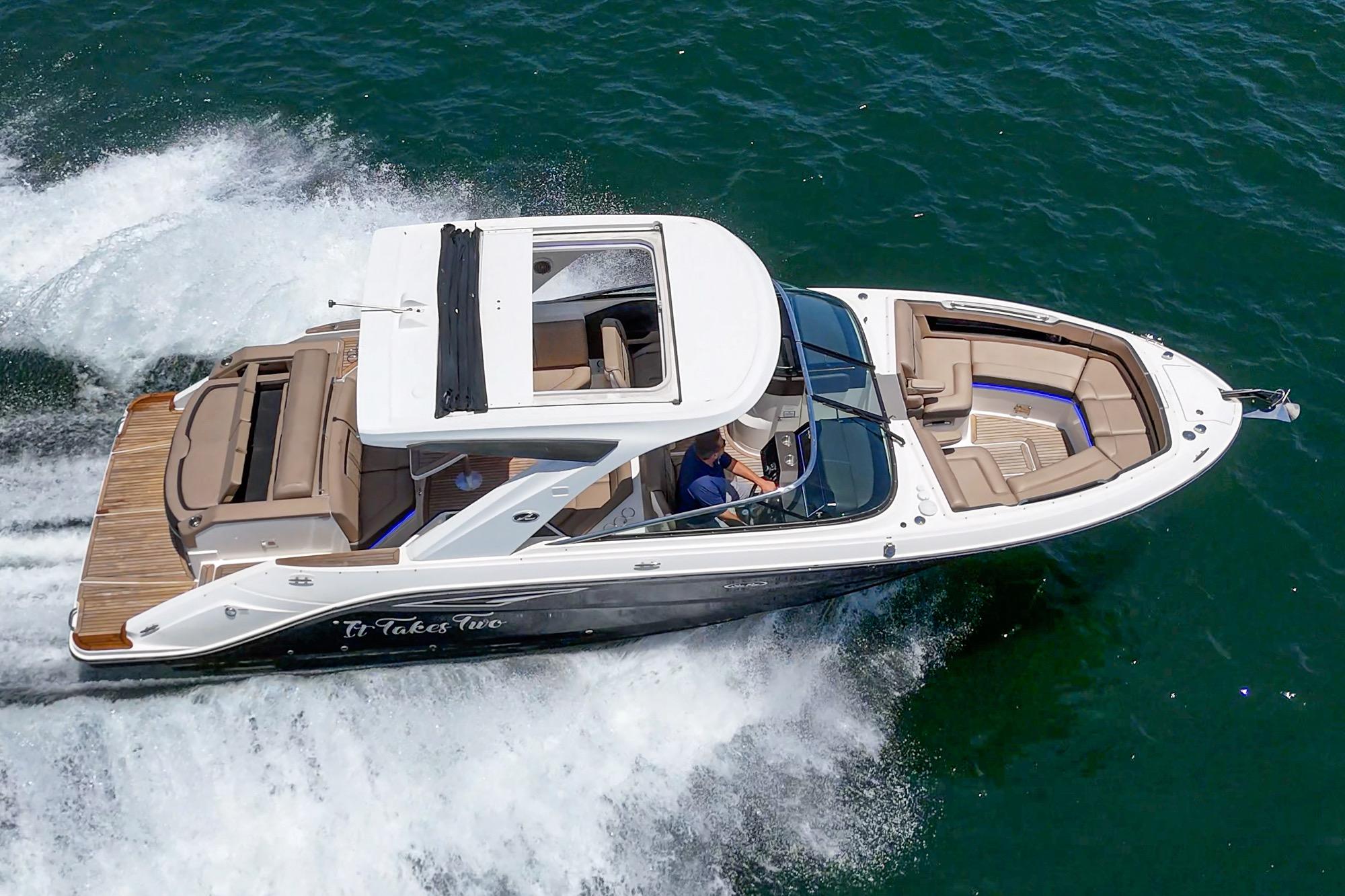 2018 Sea Ray SLX 310 cruising on open water, showcasing sleek design and spacious seating.
