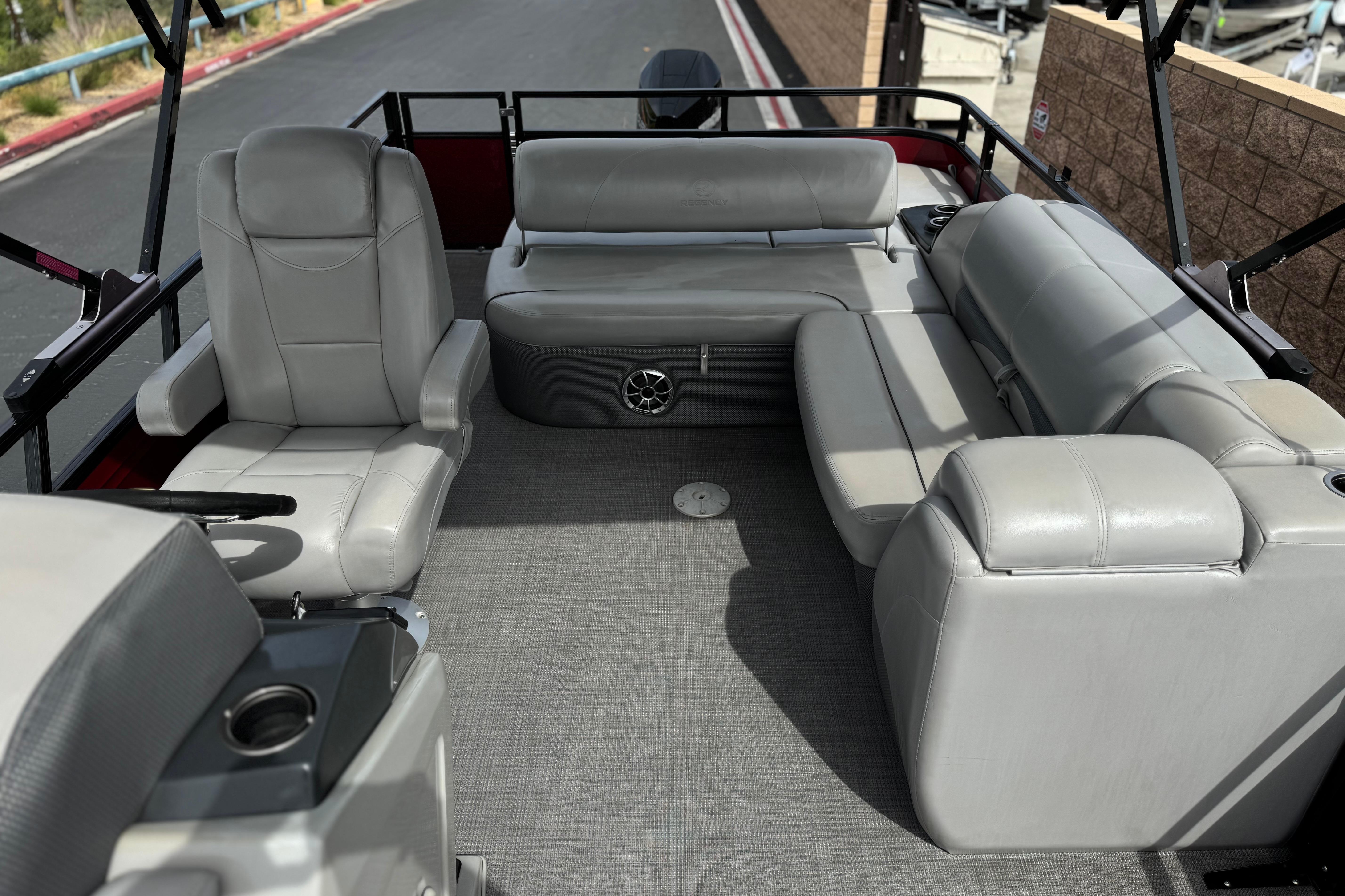 2022 Regency 250 DL3 boat interior with gray seating and carpeted floor.