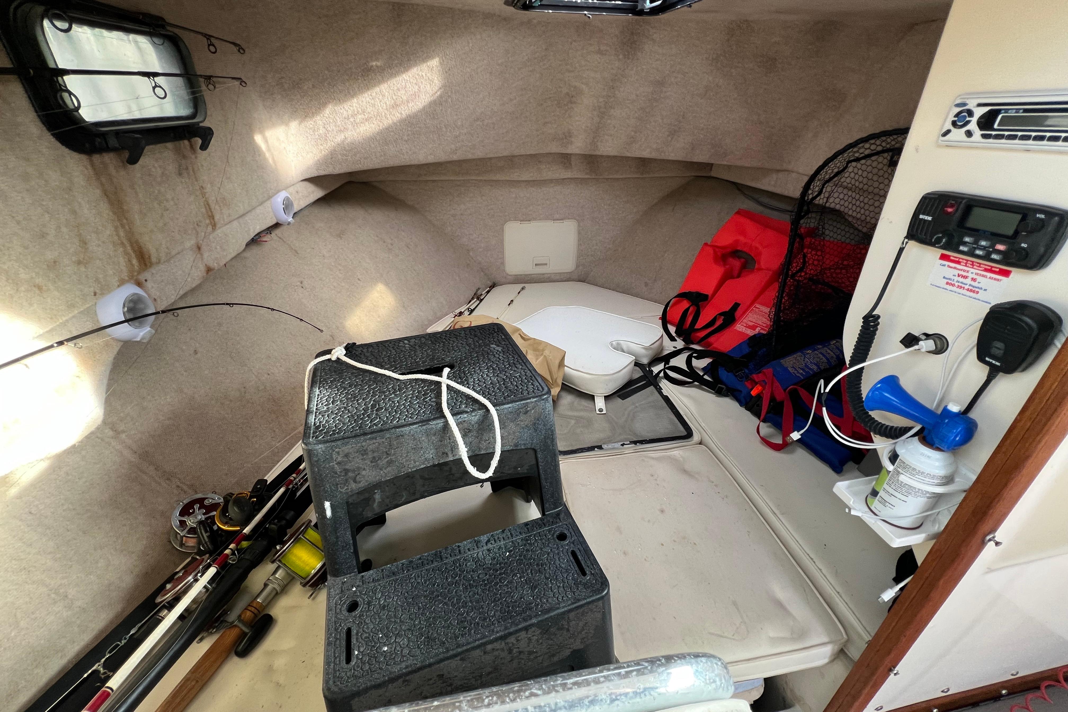 2001 Parker 2520 Deep Vee Sport Cabin interior with fishing gear and safety equipment.