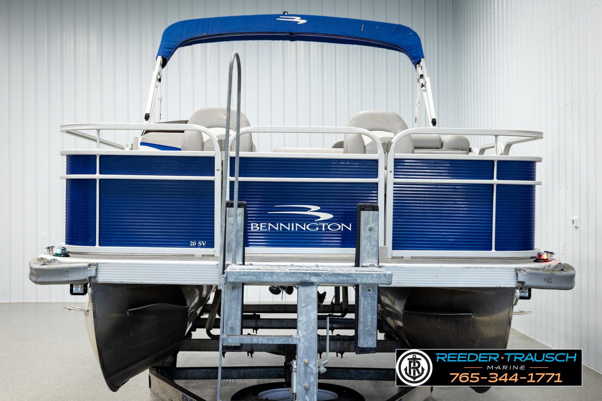2021 Bennington 20 SV pontoon boat with blue exterior on a trailer in a showroom.