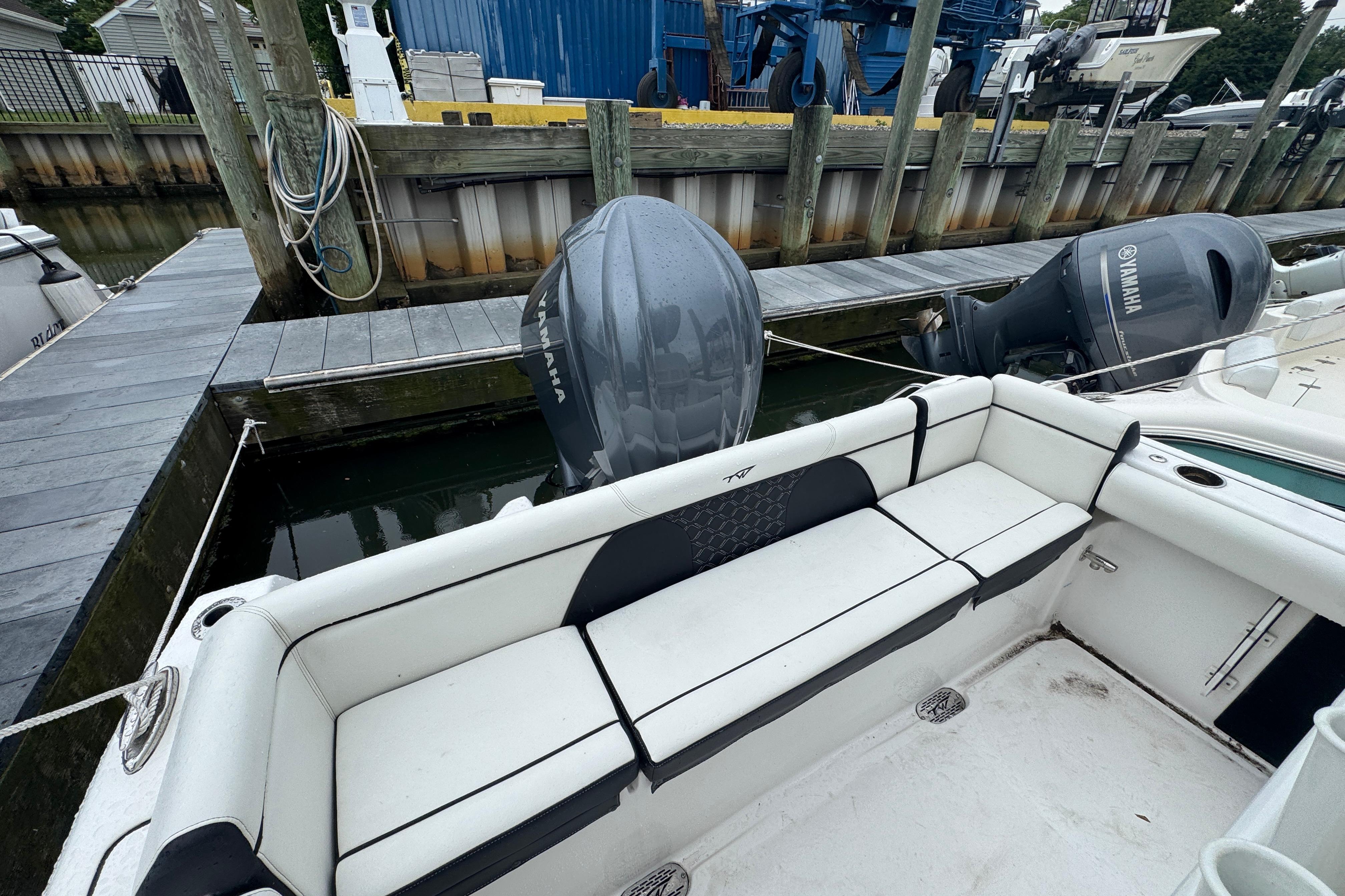 2022 Tidewater 232 SS boat docked, featuring Yamaha outboard engines and spacious seating.