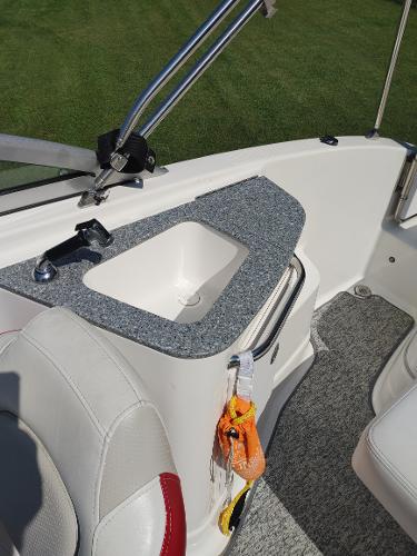 2014 Chaparral 224 Sunesta boat interior with sink and seating.