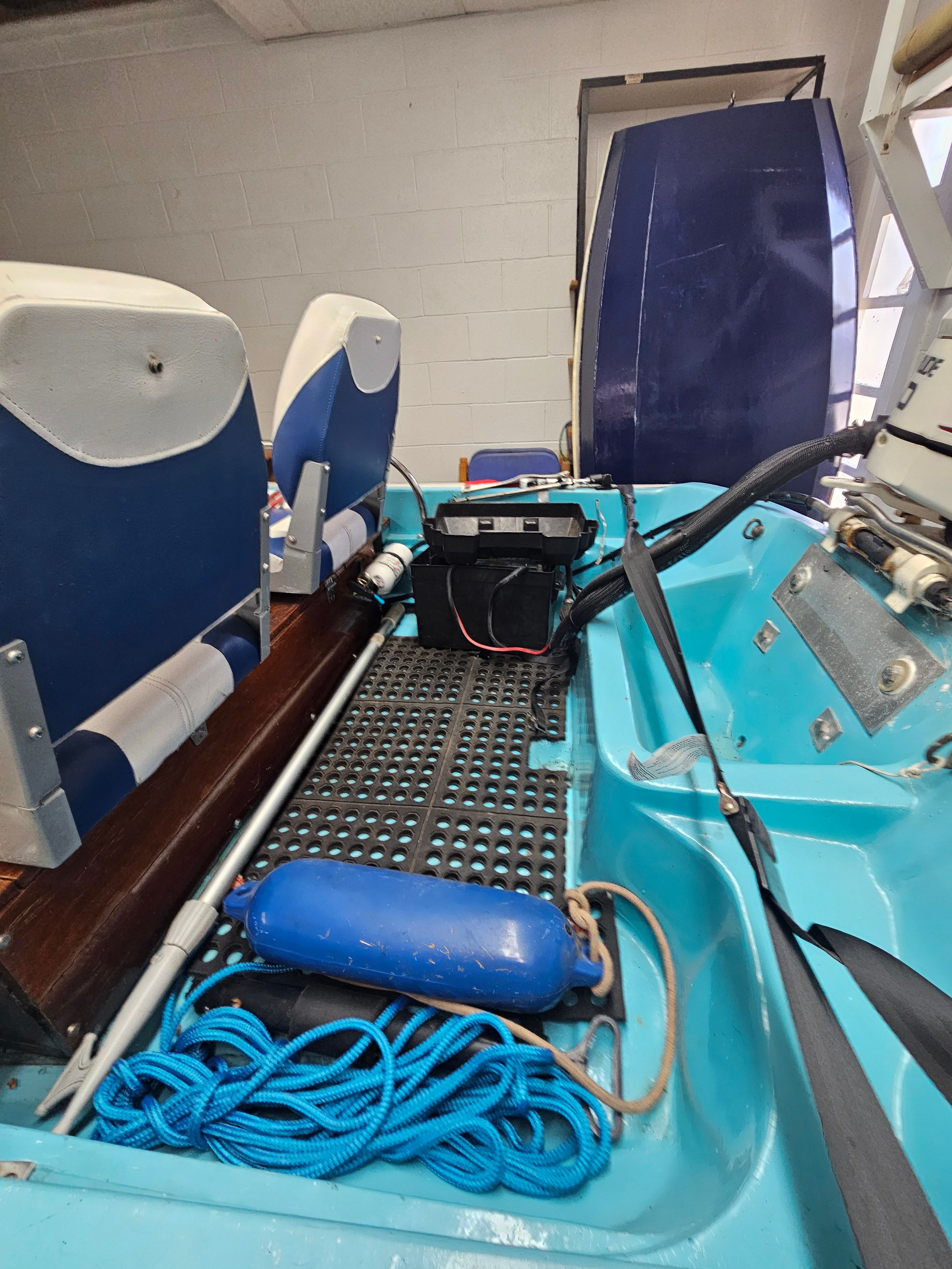 Interior of a 1977 Boston Whaler 14 boat with blue seats.