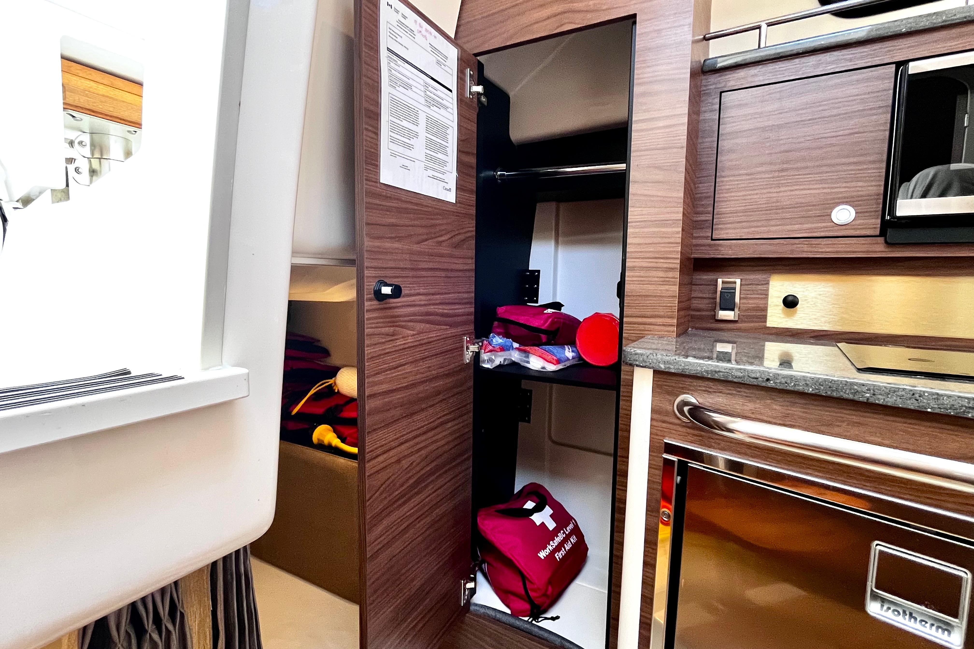 Interior of 2026 Boston Whaler 325 Conquest Pilothouse with storage and kitchenette.