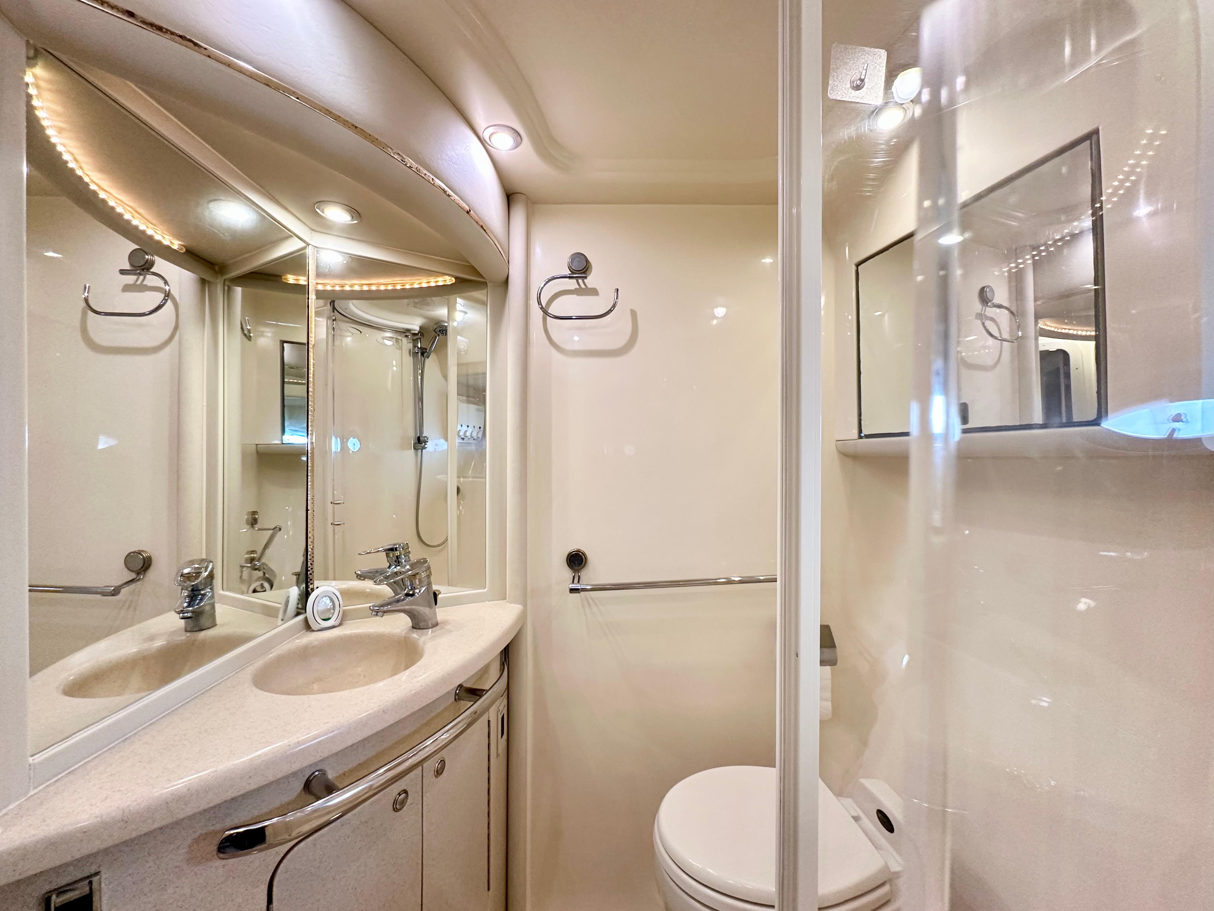 Luxurious bathroom in 2002 Sea Ray 560 Sedan Bridge yacht with modern fixtures.
