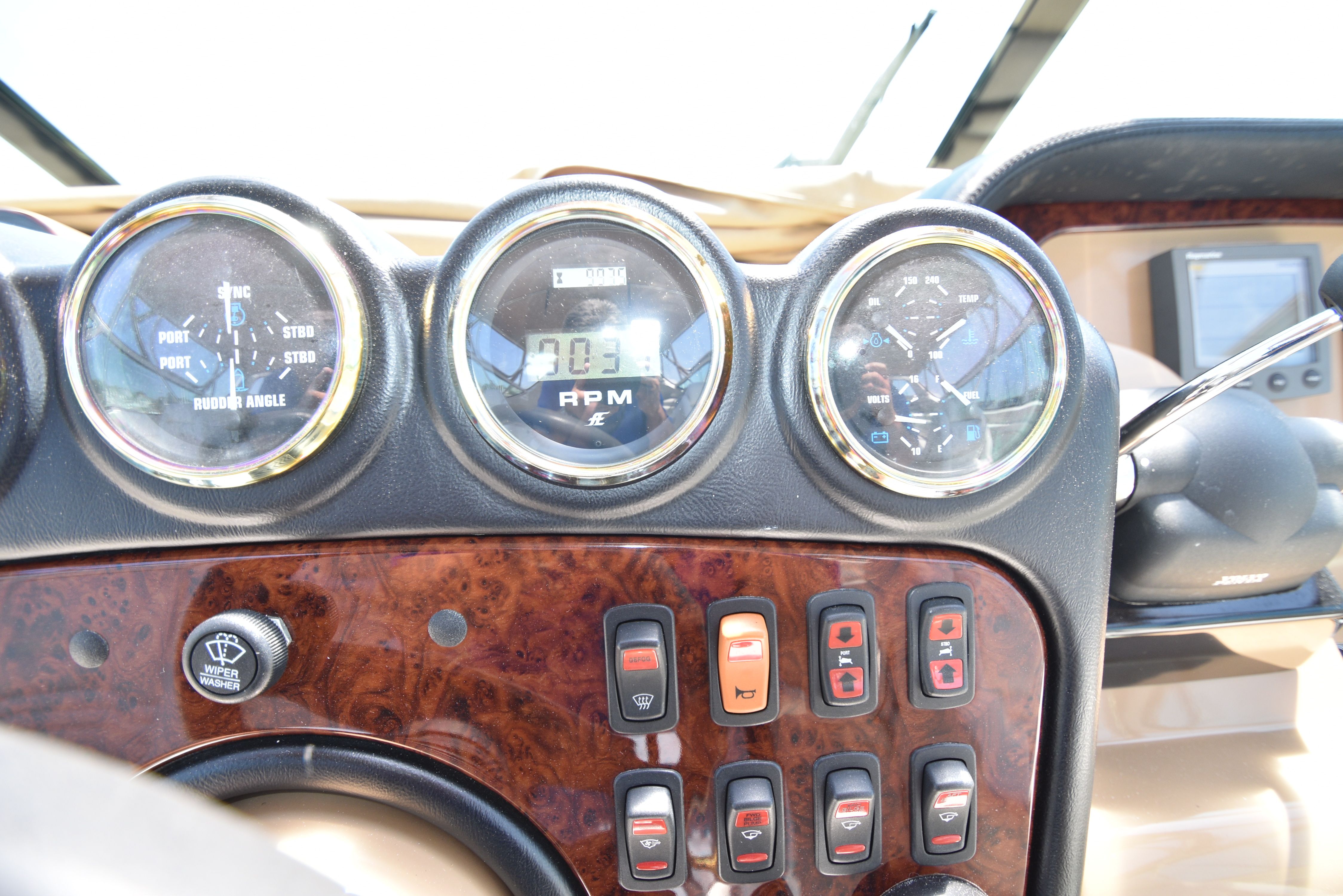 Close-up of the dashboard on a 2004 Carver 466 Motor Yacht, featuring gauges and switches.