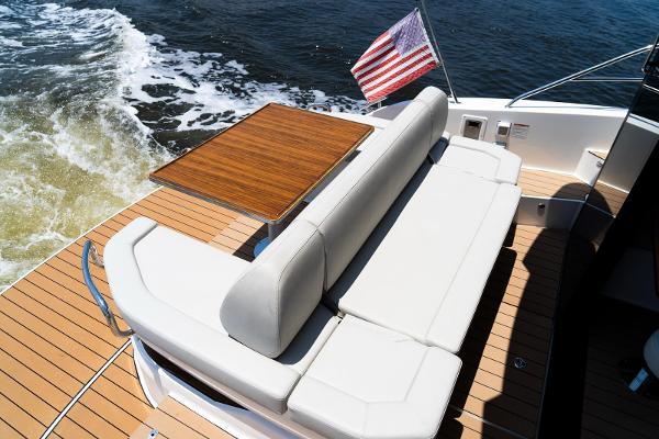 Luxury Bavaria SR41 yacht deck with seating, table, and American flag, 2022 model.