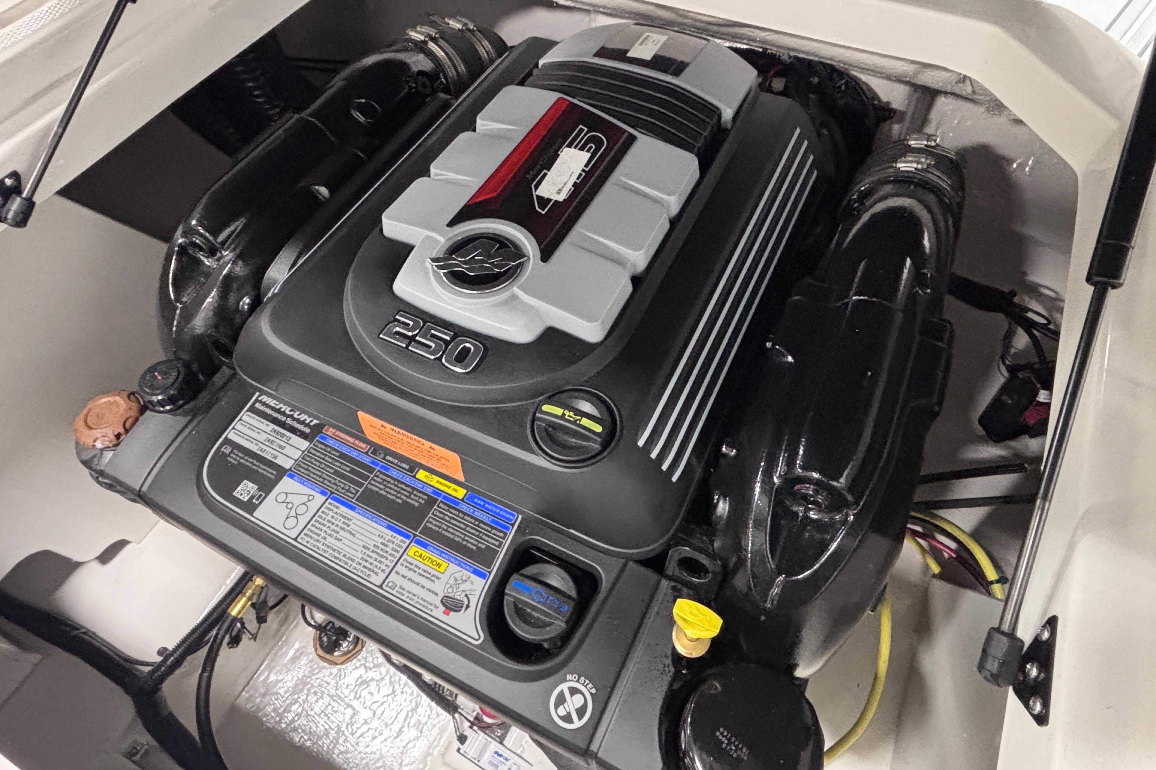 Engine compartment of 2026 Chaparral 21 SSi boat, featuring a powerful 250 horsepower engine.