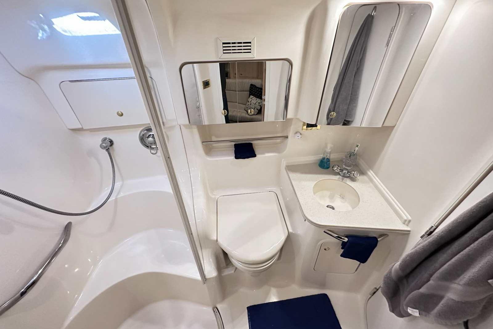 Luxurious bathroom in 2000 Sea Ray 410 Sundancer yacht, featuring modern fixtures and elegant design.