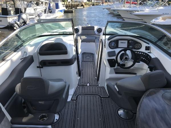 2020 Rinker 29QX BR boat interior with steering wheel and seating.