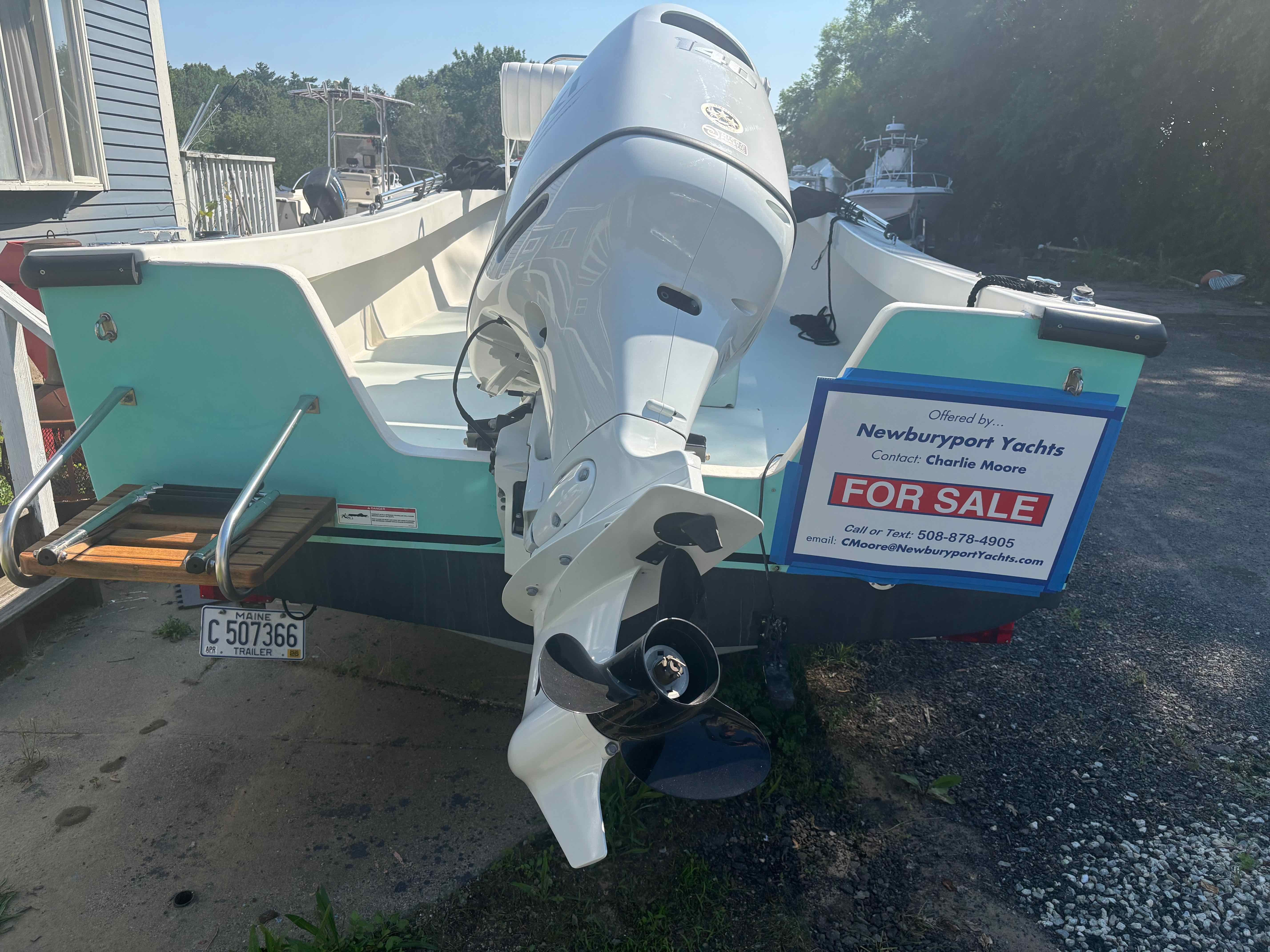 A 2016 Surfside 21 Center Console boat with an outboard motor, on a trailer for sale.