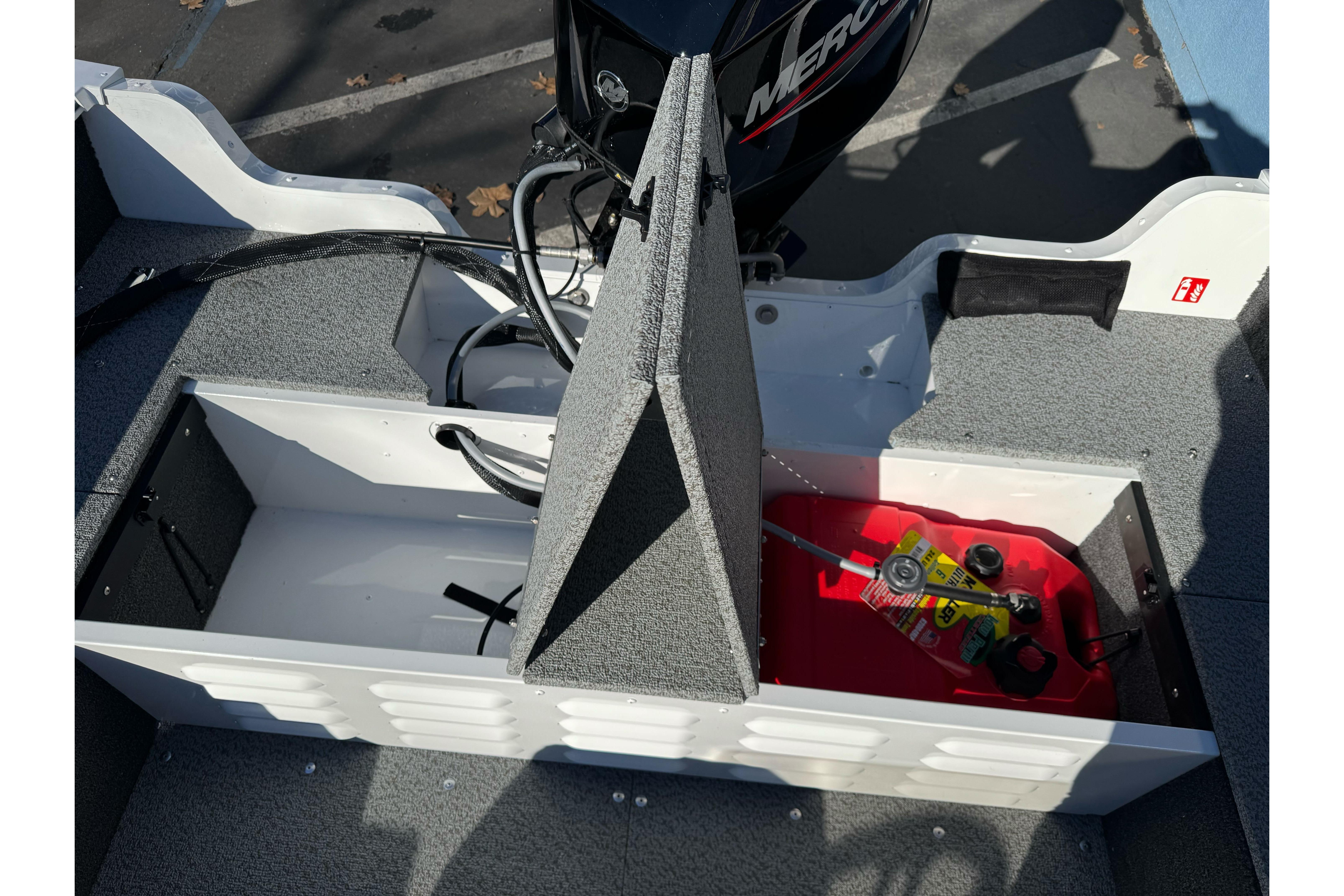 2026 Lund 1650 Angler SS boat interior with storage compartments and Mercury engine.