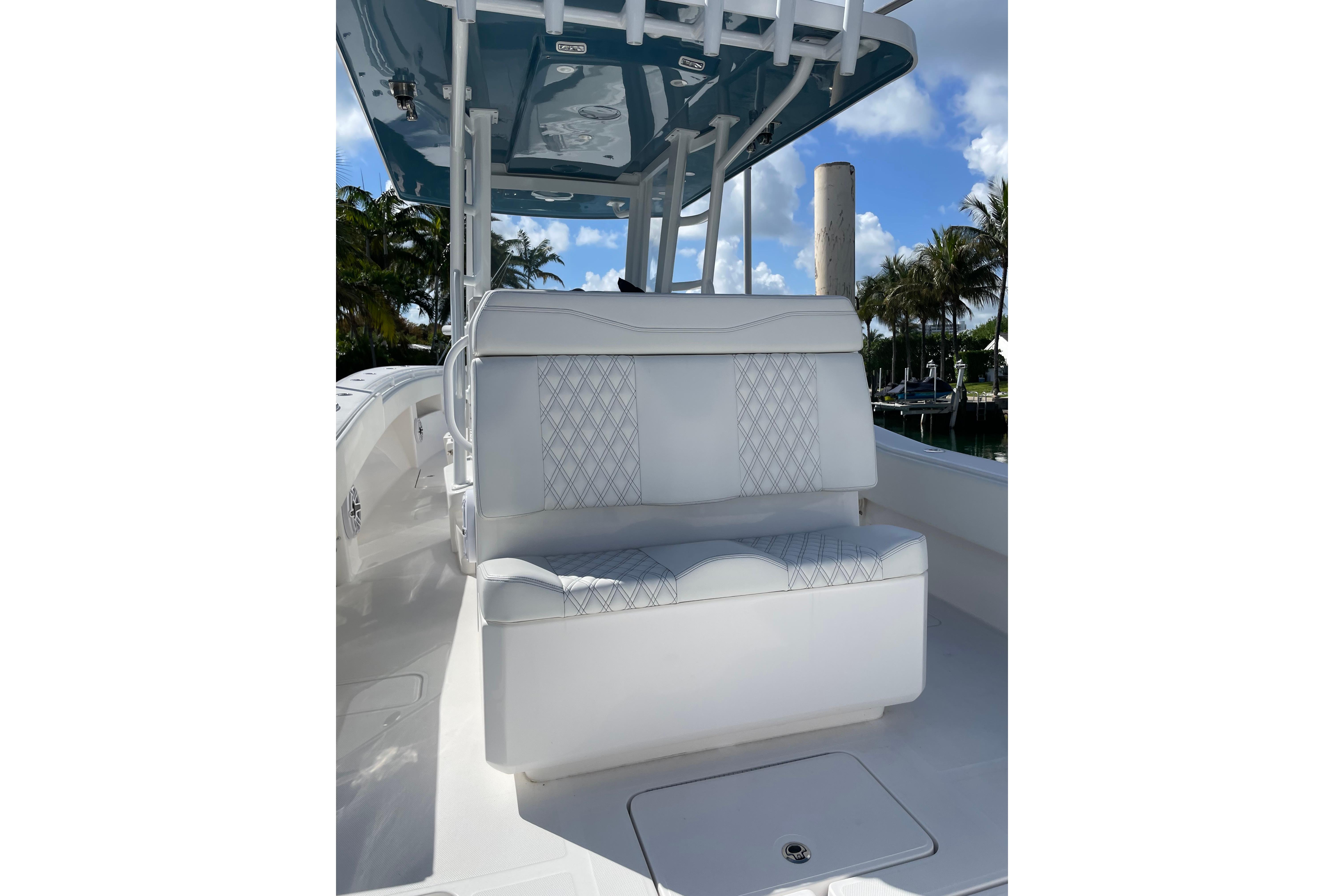 2024 Invincible 36 Open Fisherman boat with white seating and blue canopy.