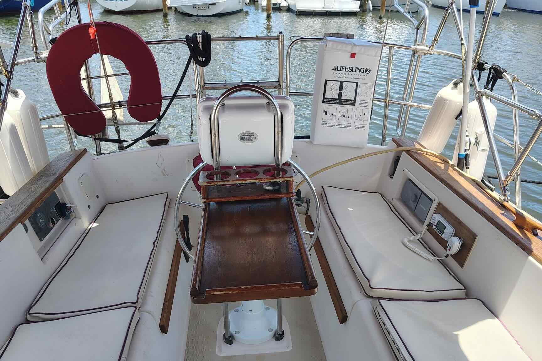 Cockpit of 1989 Island Packet 35 sailboat with seating and safety equipment.