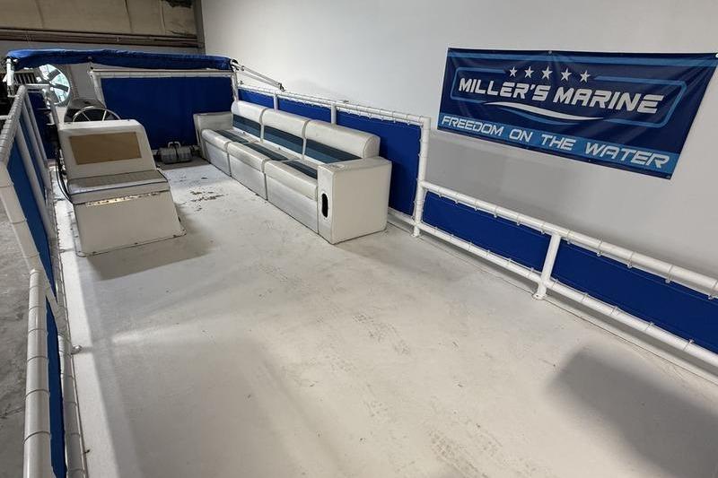 1993 Monark Sun Caster 240 CR 4 Point pontoon boat interior with seating and steering console.