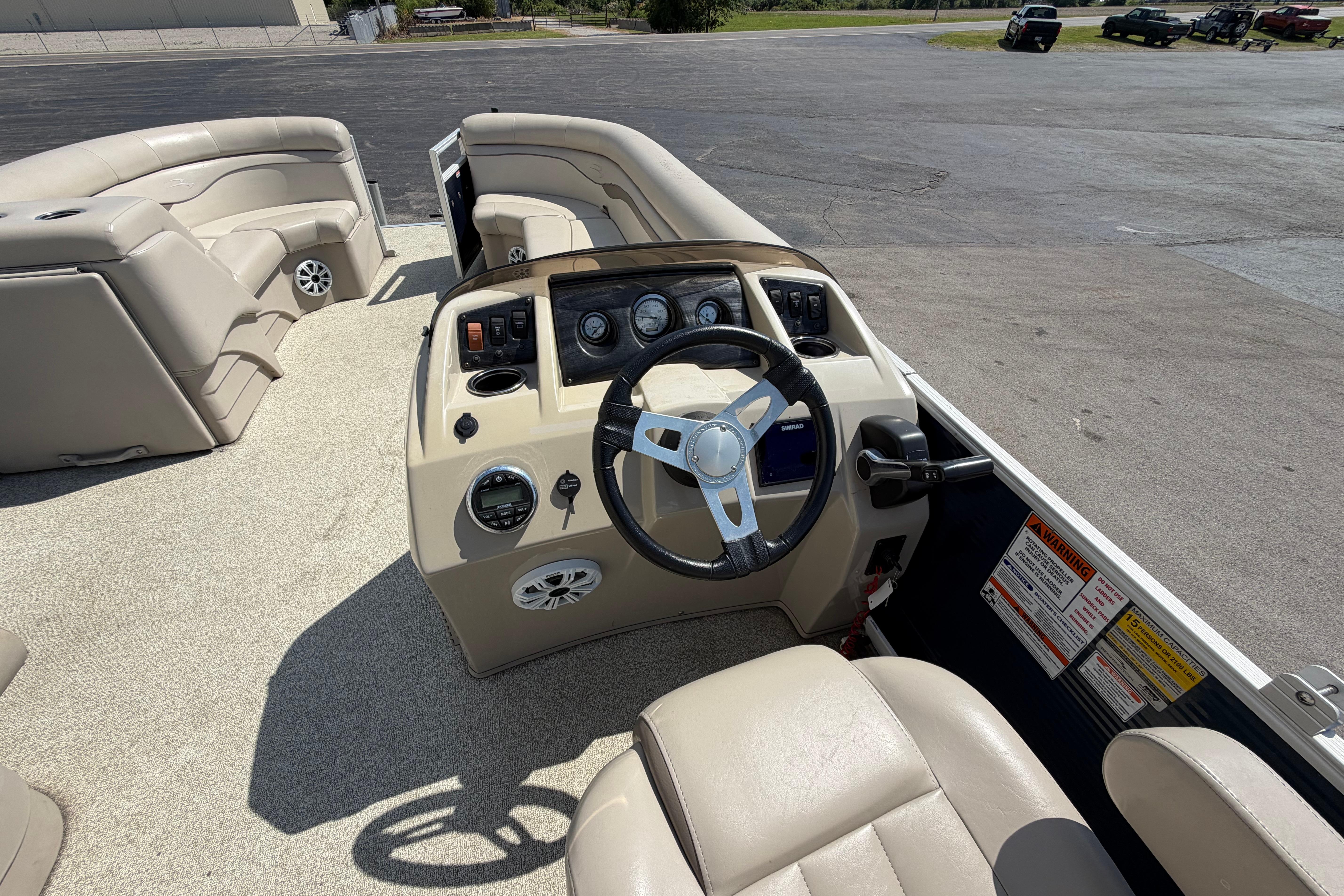 2017 Bennington 25 SSXAPG boat interior with steering wheel and seating area.
