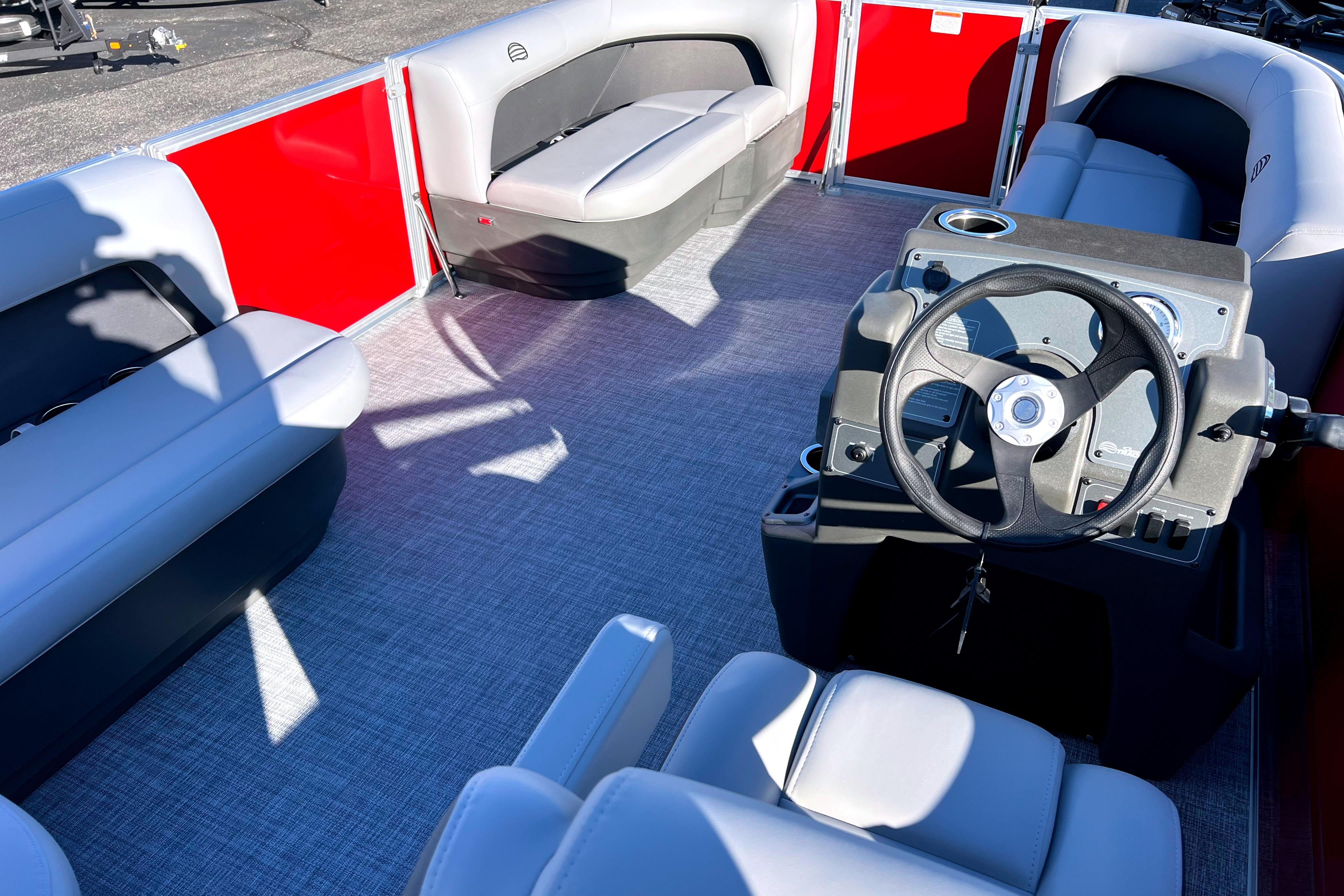 2026 Sun Tracker Party Barge 16 DLX interior with seating and steering console.